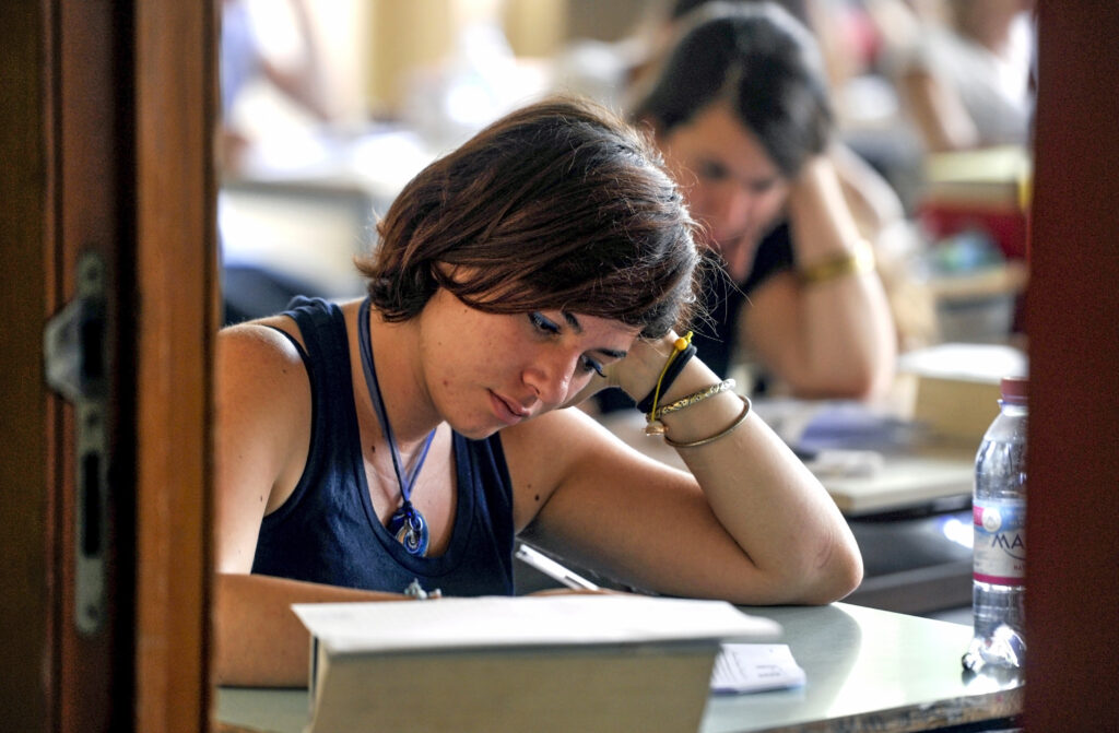 Milan,,Italy-june,20,,2012:,College,Students,Seat,On,School,Desk