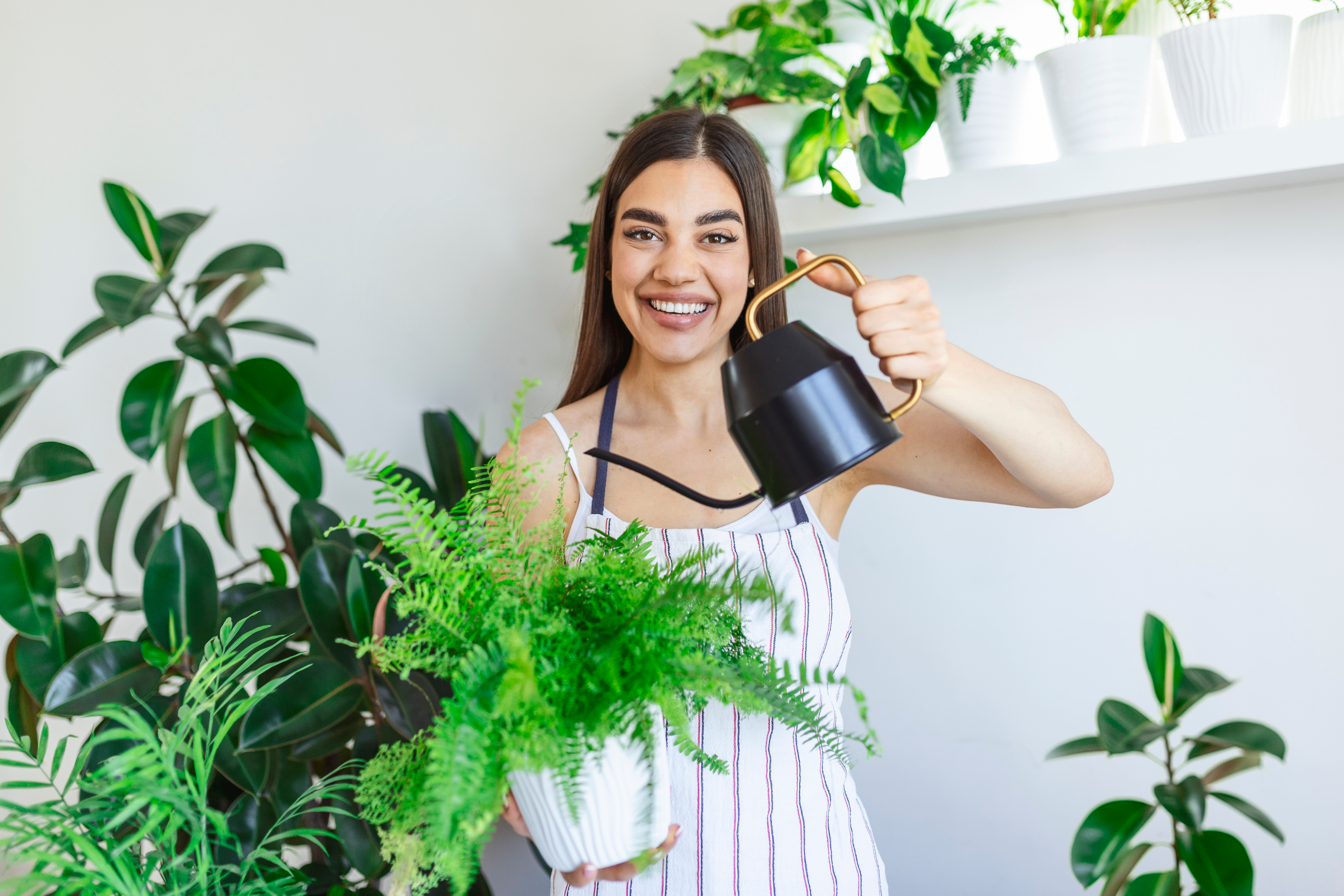 Joyful,Young,Woman,Enjoys,Her,Time,At,Home,And,Watering