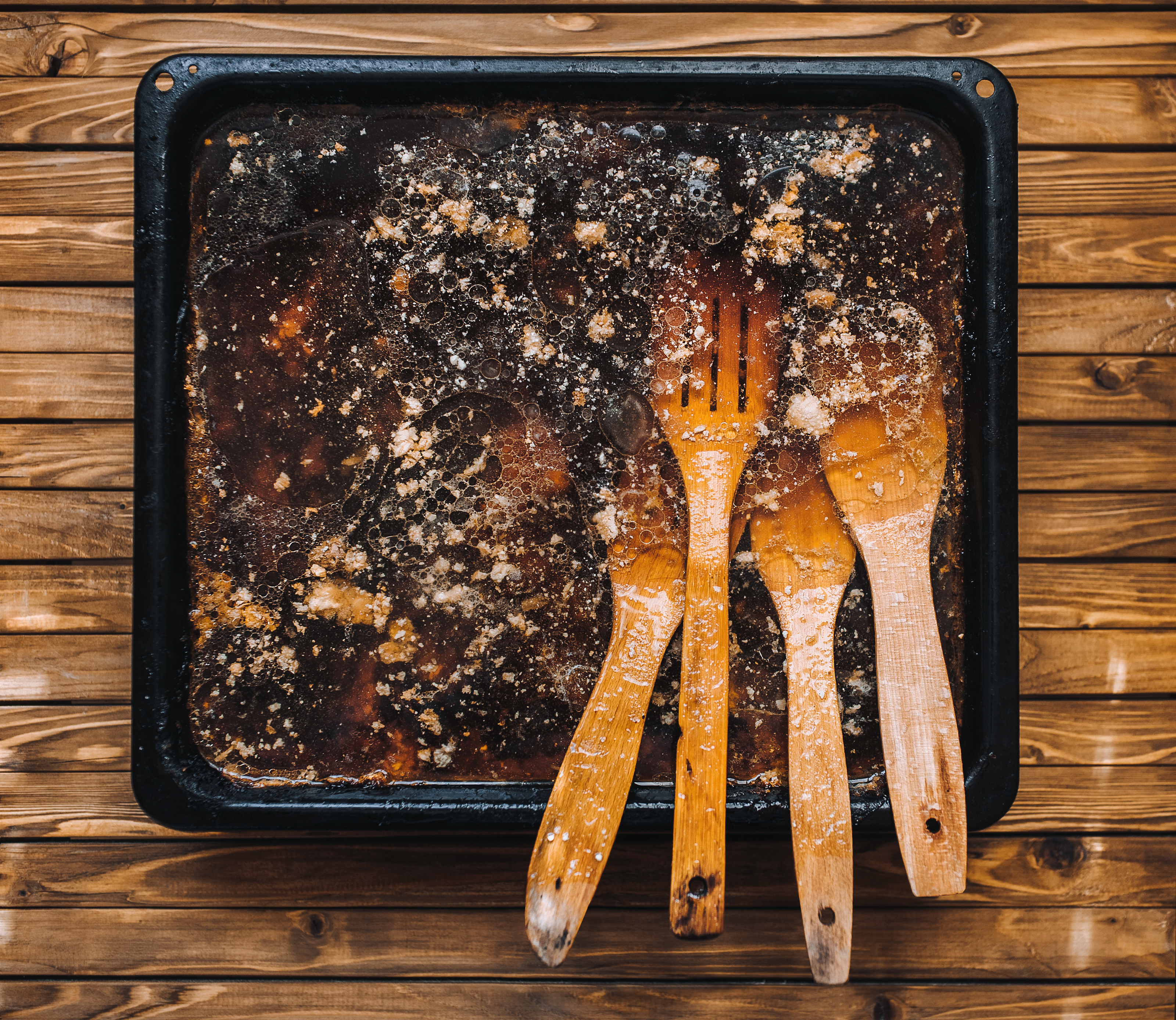 Wooden,Spatula,In,Fat,On,A,Baking,Sheet.,Dirty,Dishes.