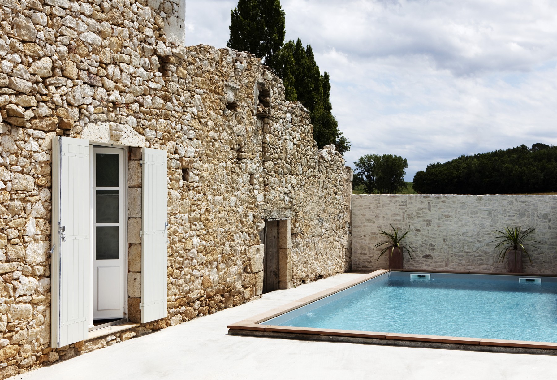 Stone wall beside swimming pool