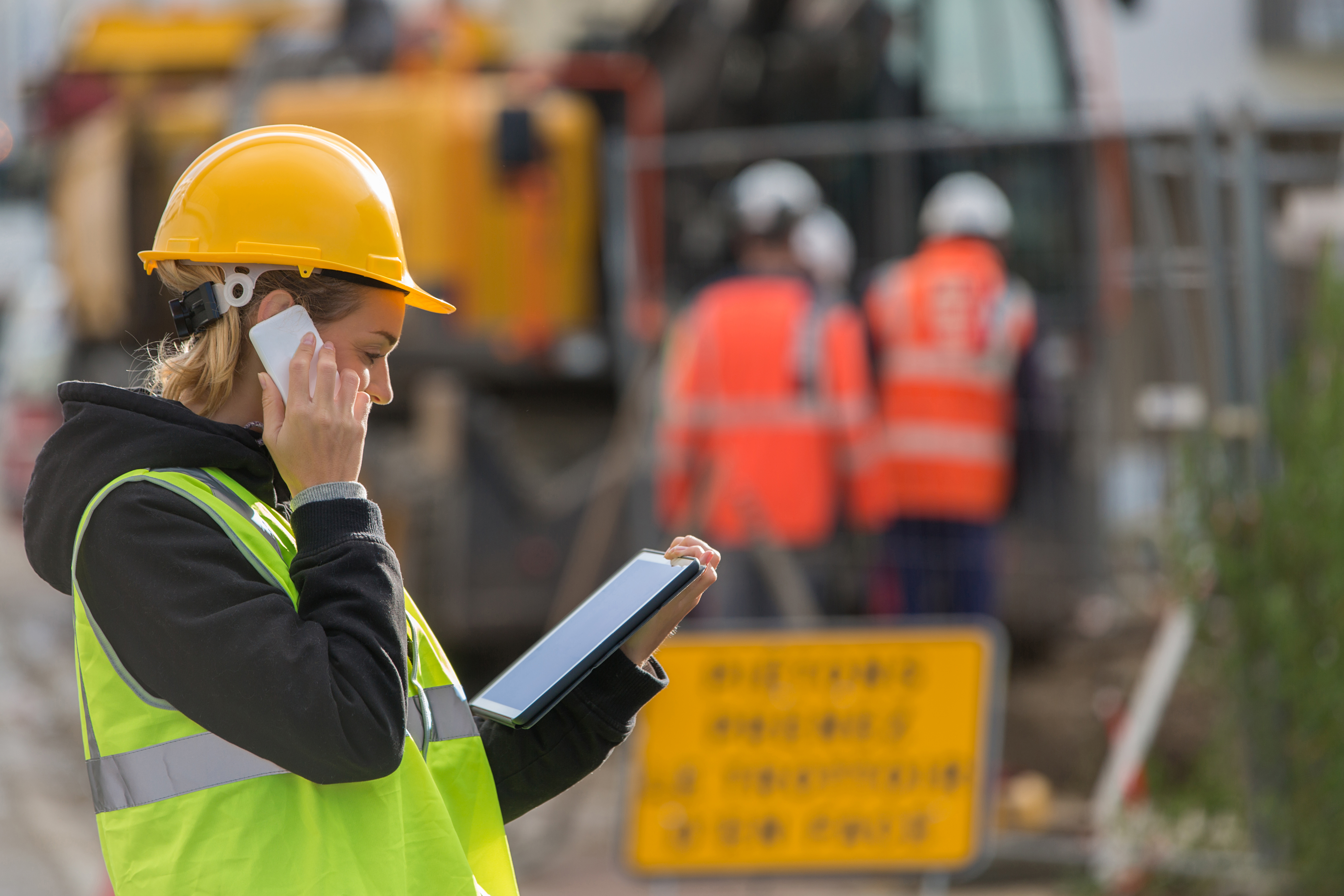 Female,Construction,Woman,Using,Electronics,On,Construction,Site