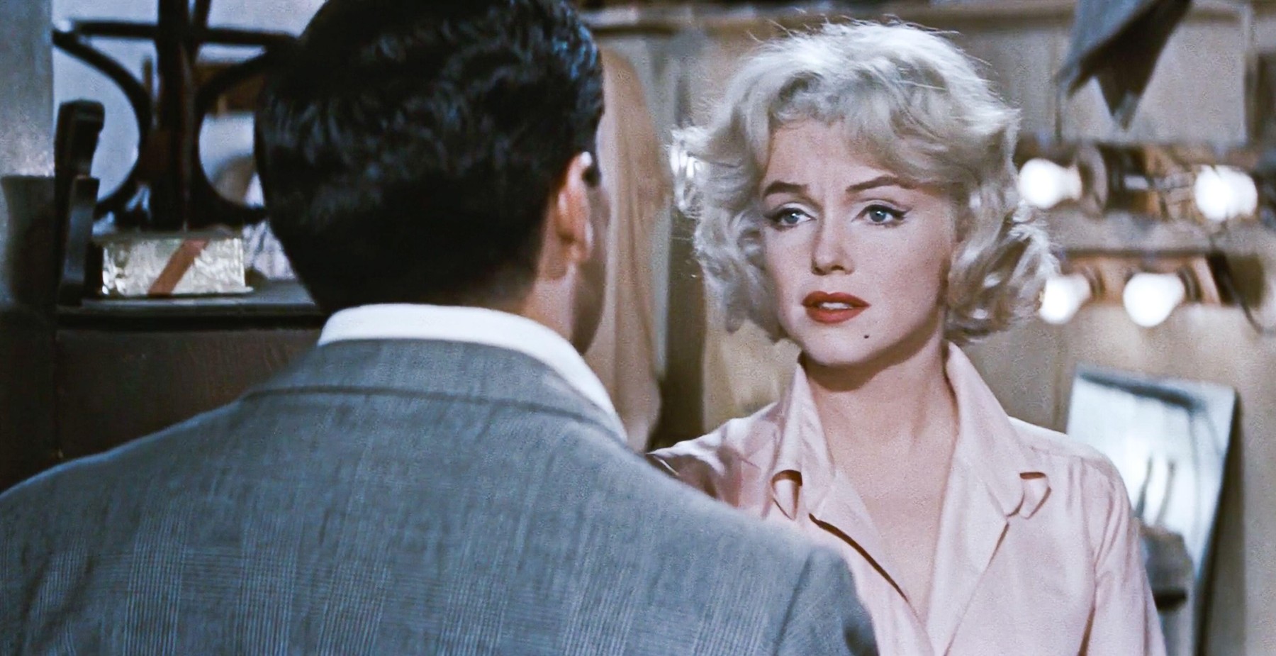 USA. Marilyn Monroe  and Frankie Vaughan  in a scene from the ©Twentieth Century Fox movie:  Let's Make Love (1960) . Plot: When billionaire Jean-Marc Clement learns that he is to be satirized in an off-Broadway revue, he passes himself off as an actor p