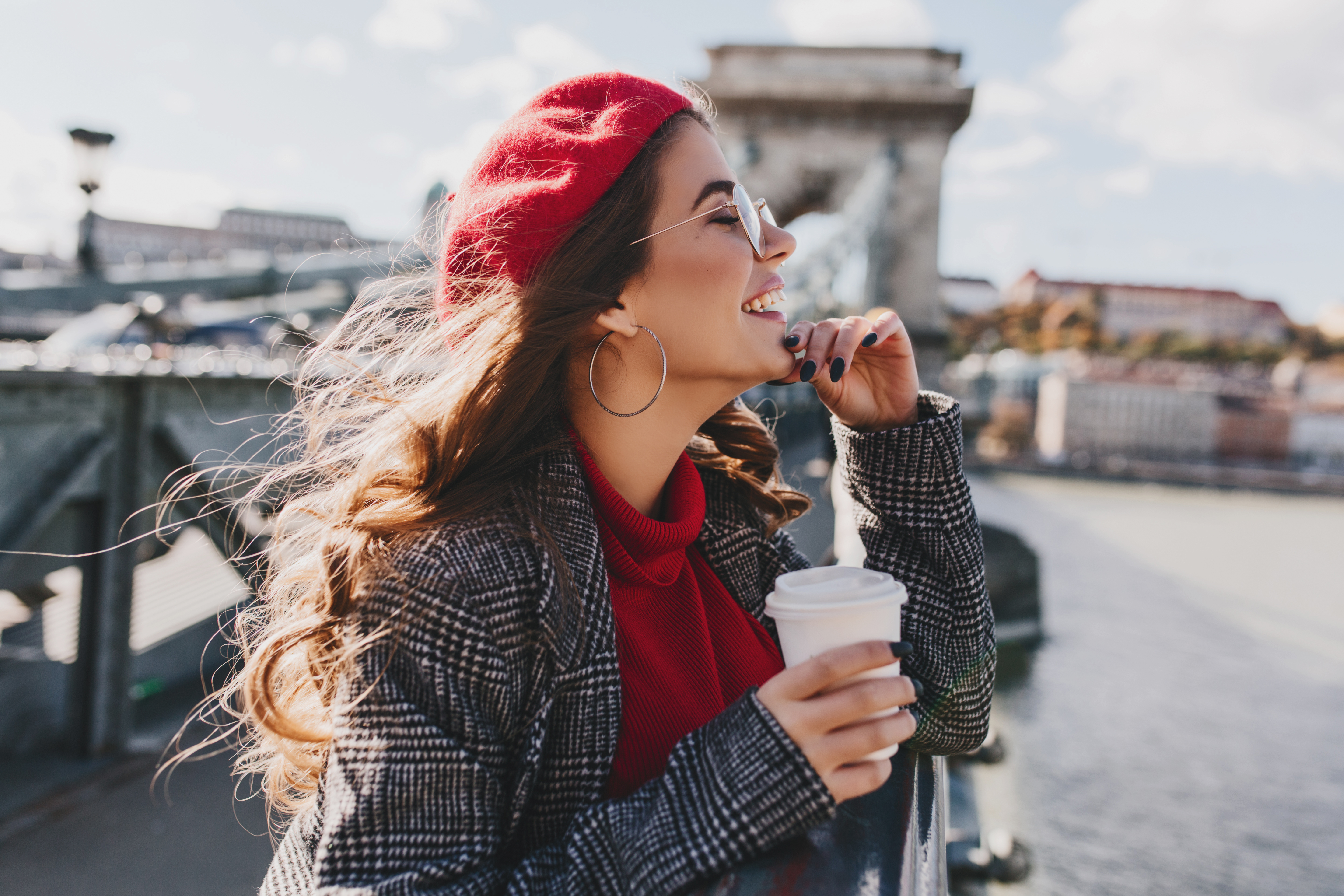 Carefree,Caucasian,Woman,In,Red,Hat,Enjoying,City,Views,In