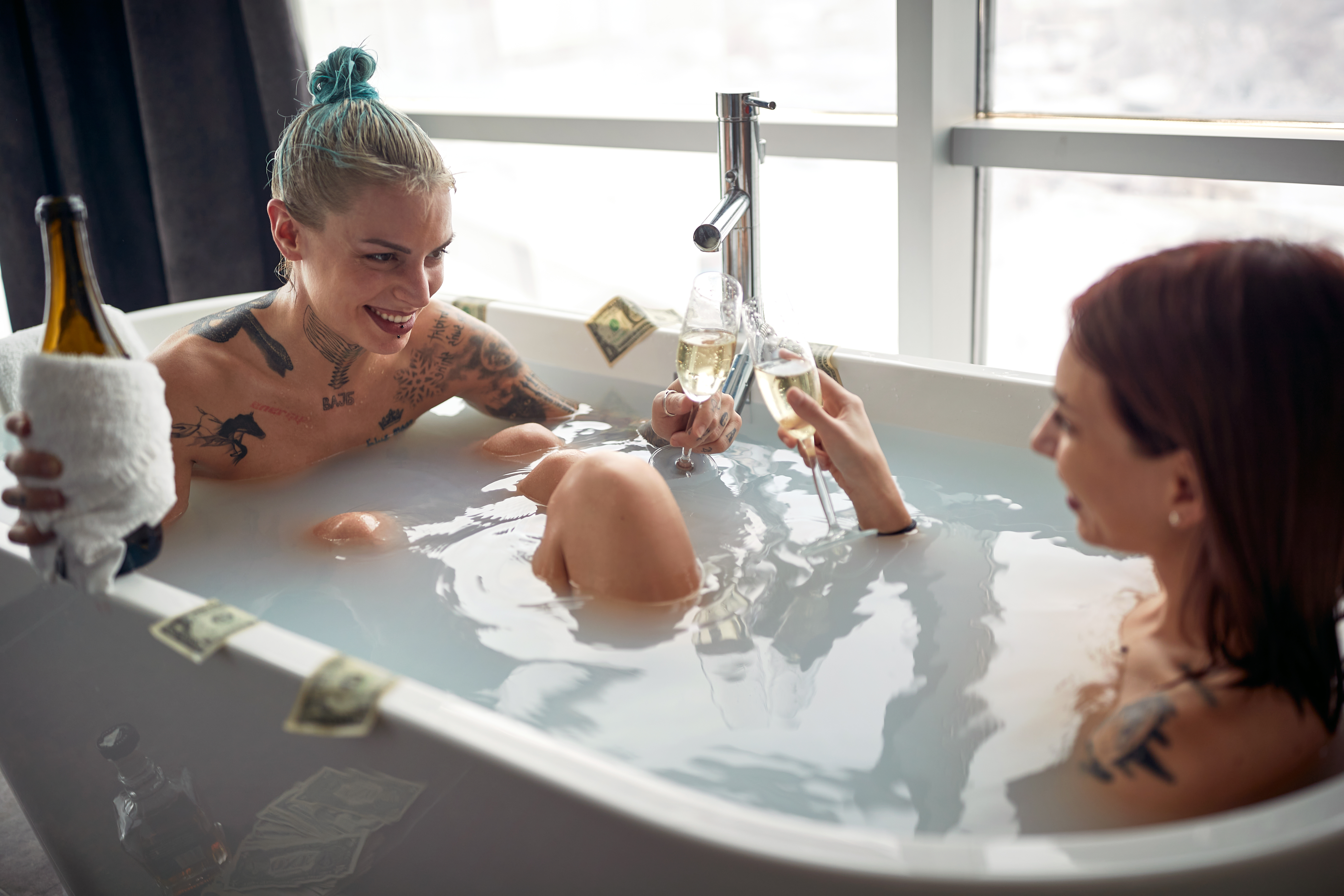 A,Young,Sexy,Tattooed,Lesbian,Couple,Enjoying,Champagne,While,Having