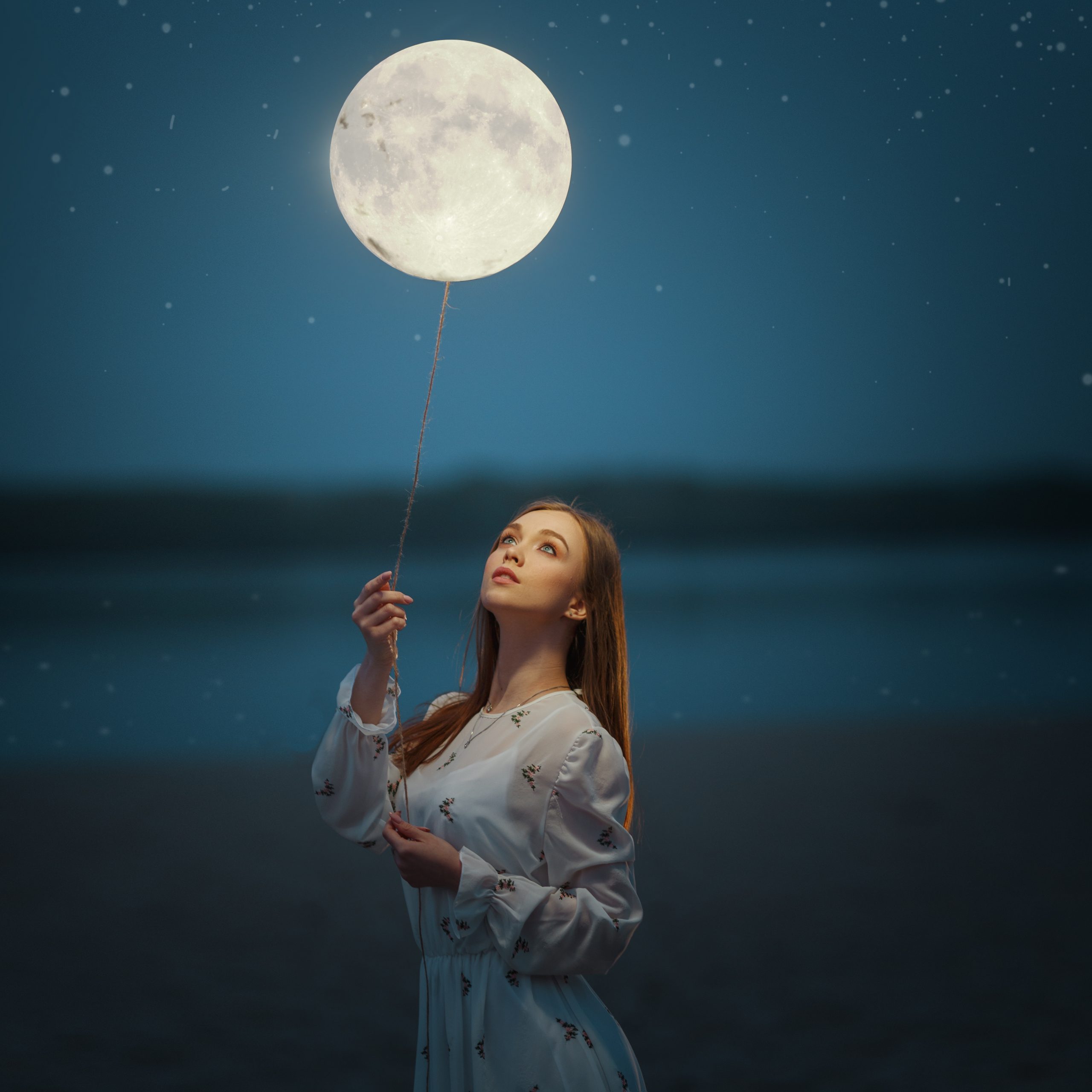 Young,Attractive,Girl,Holds,A,Tied,Moon,On,A,Rope.