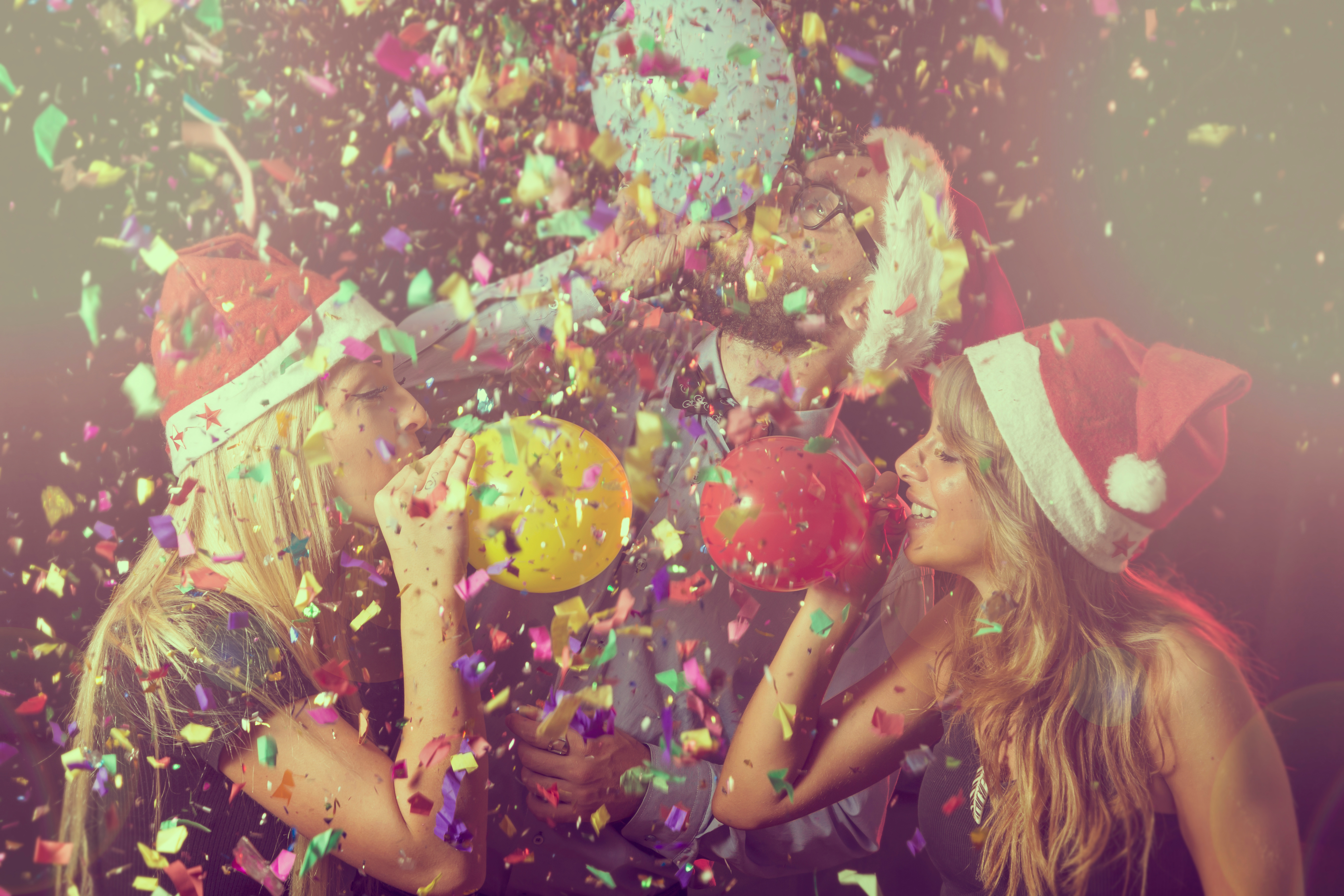 Three,Young,People,At,New,Year's,Eve,Party,On,Midnight