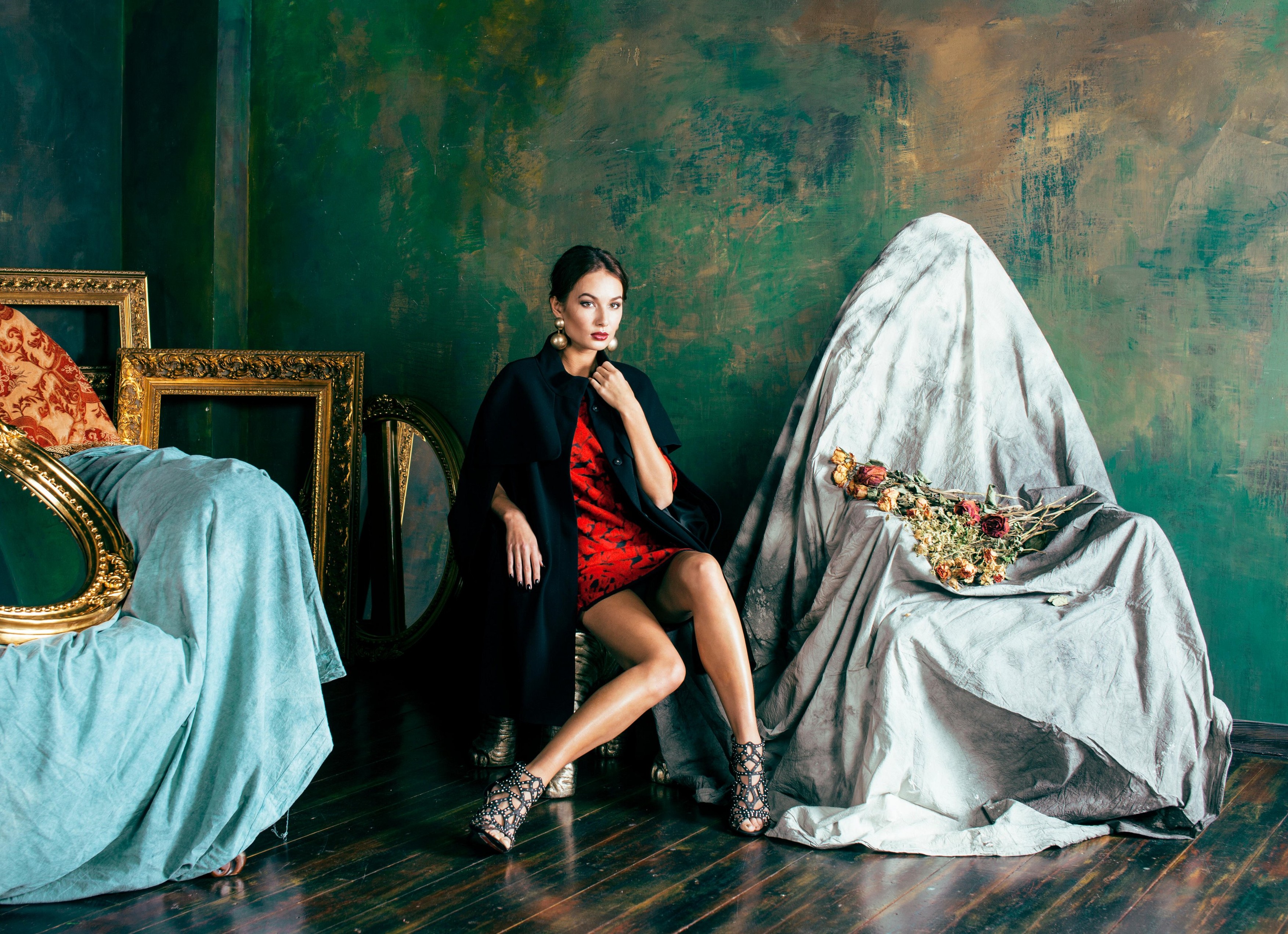 beauty rich brunette woman in luxury interior near empty frames, wearing fashion clothes, lifestyle people concept