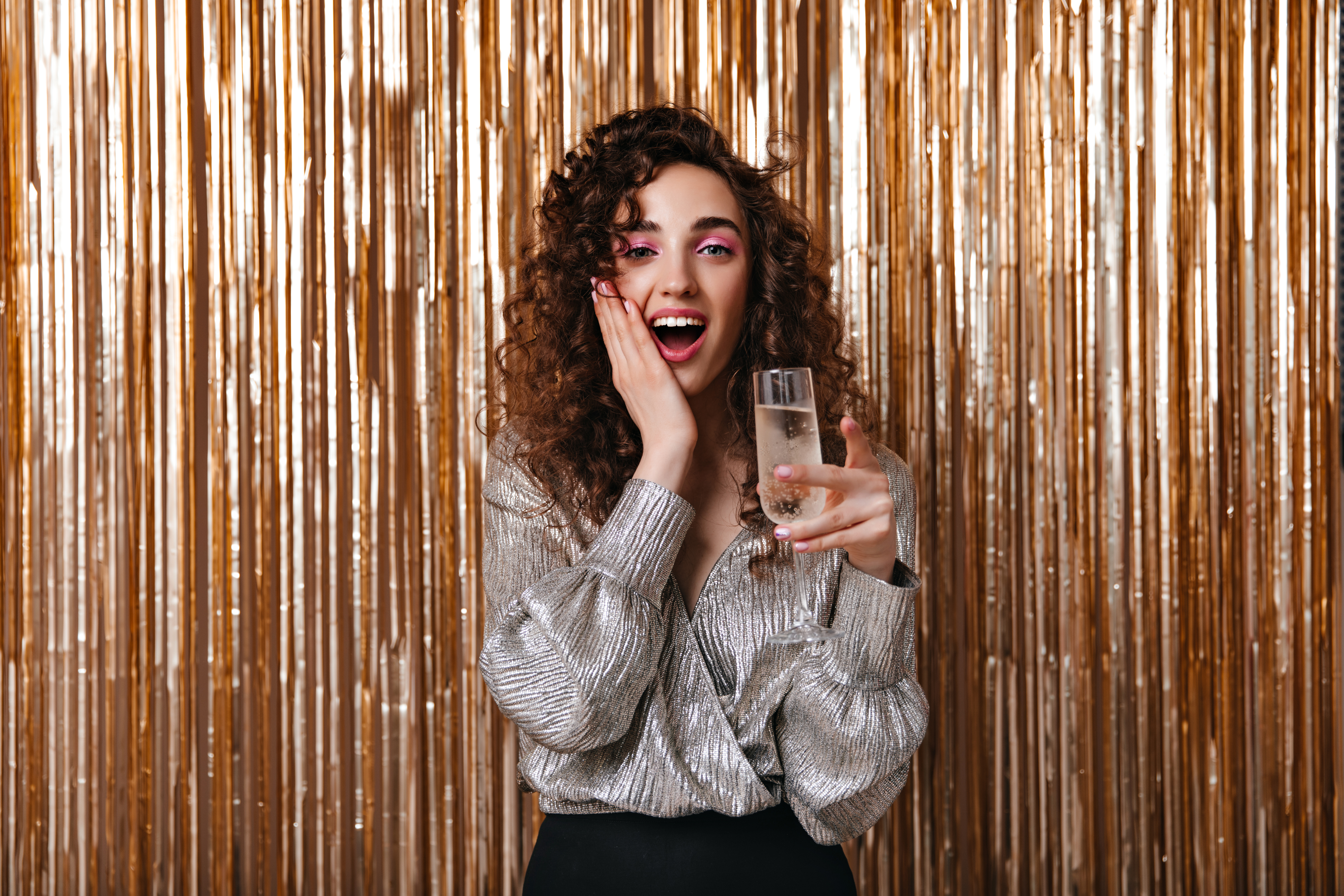 Surprised,Woman,In,Silver,Blouse,Holding,Champagne,Glass