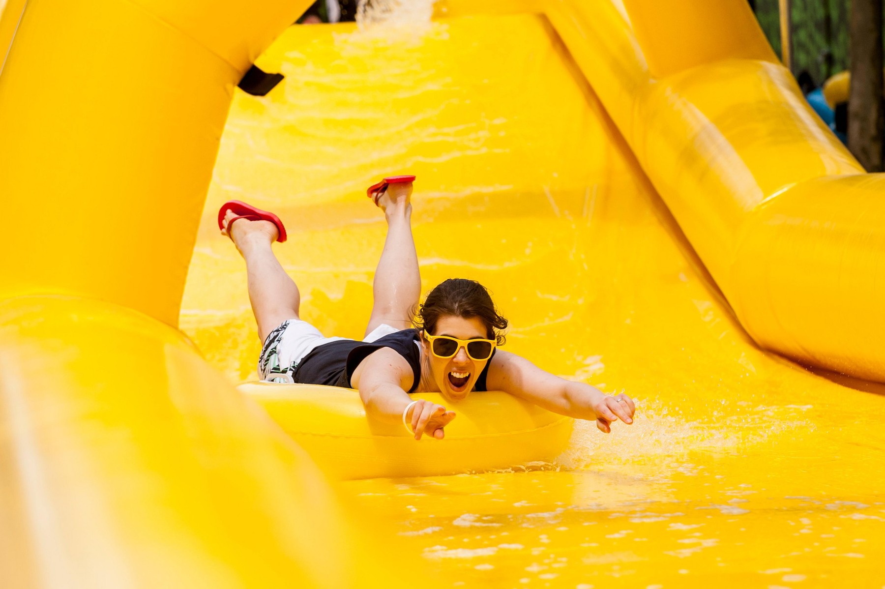 London, UK. 19 June 2015. A girl enjoys the slide, as Lipton promotes its ice tea with a free 100m water slide for members of the public to enjoy for two days at King's Boulevard, King's Cross. © Stephen Chung / Alamy Live News