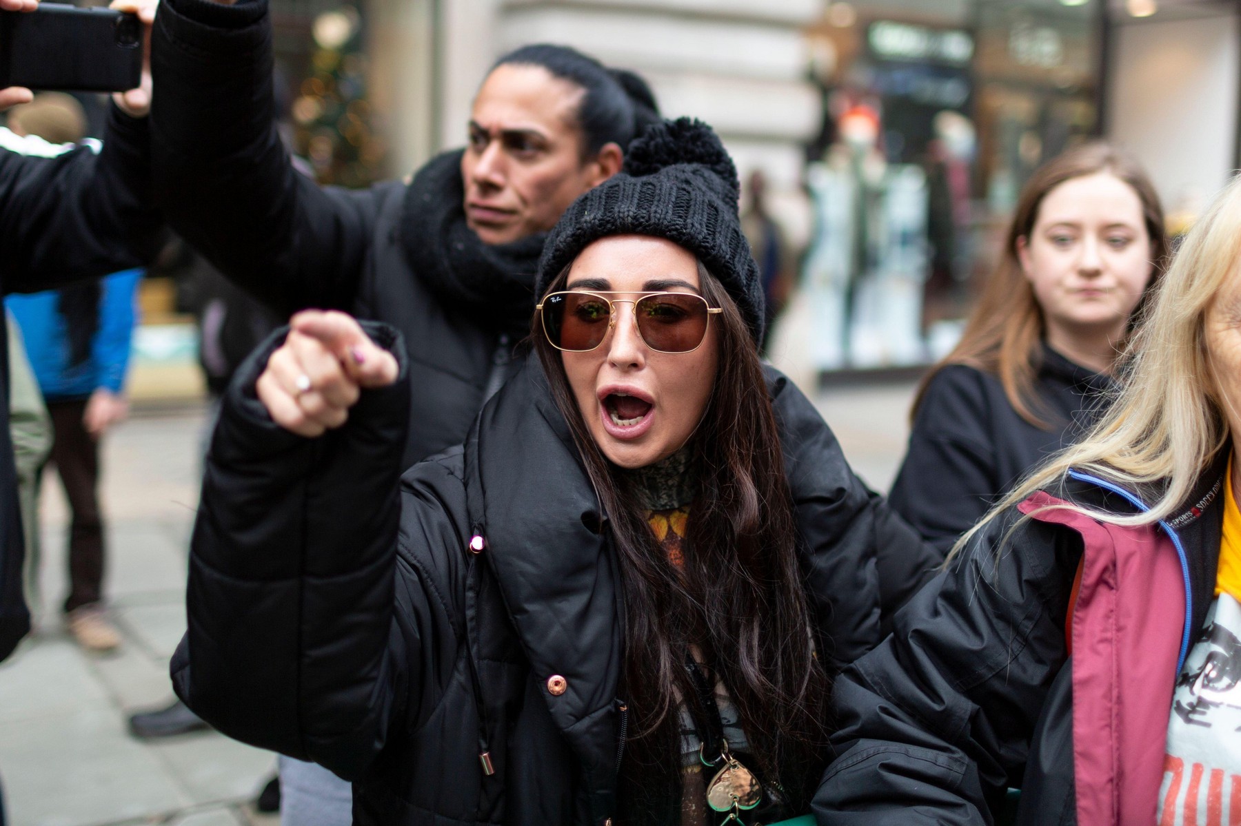 Anti-lockdown protest, Regent Street, London, 28 November 2020. A girl points her finger and berates police officers for arresting a fellow protester.