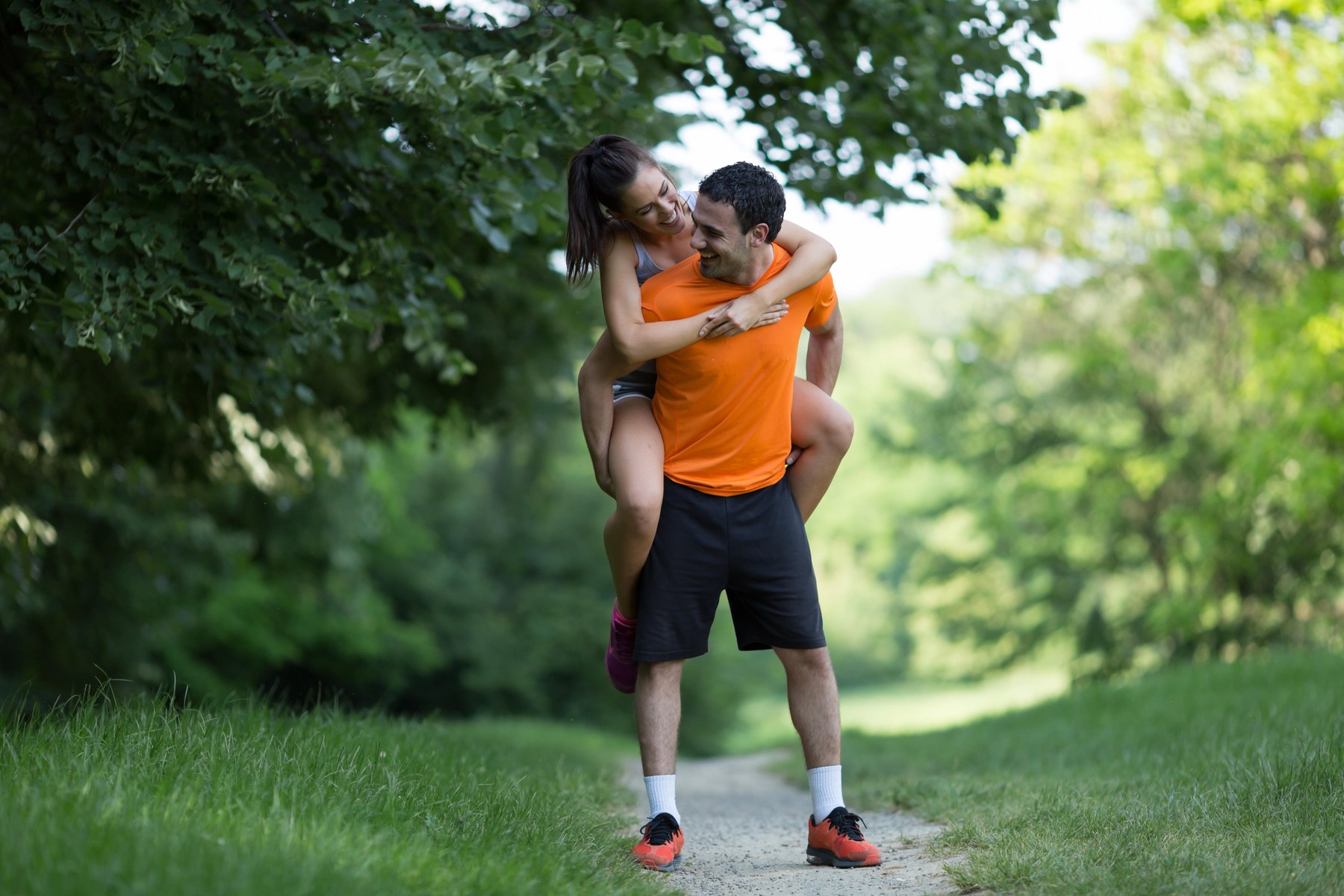 Man carrying woman he loves piggyback