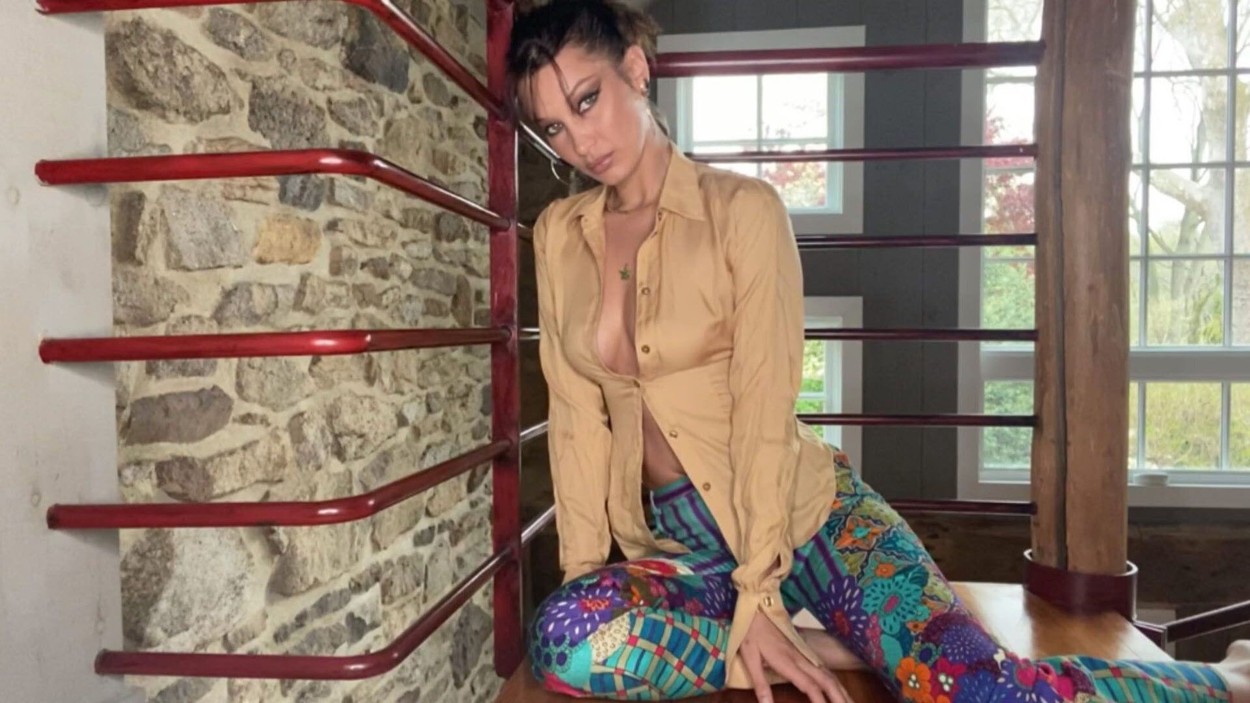 Stunning model Bella Hadid flashes a lot of lockdown cleavage in an open shirt.