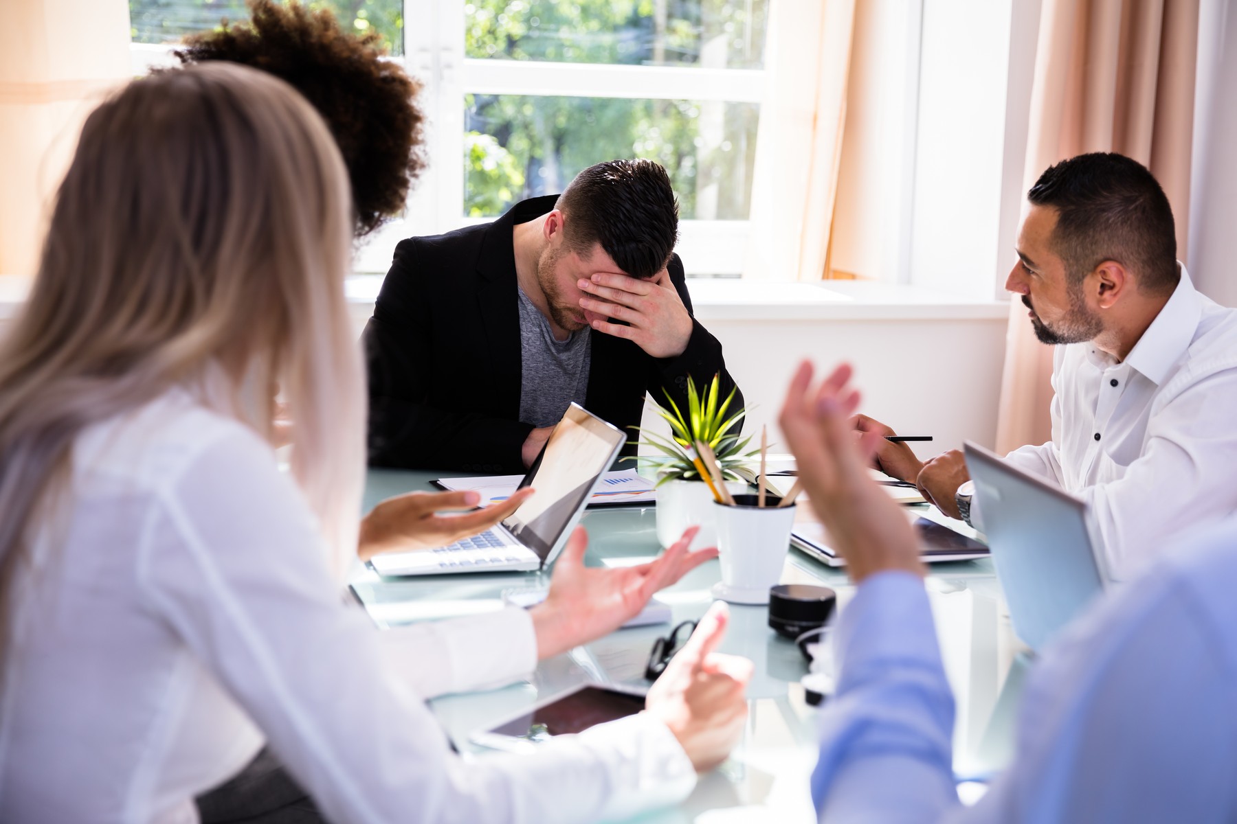 Businesspeople Blaming Their Colleague In Office