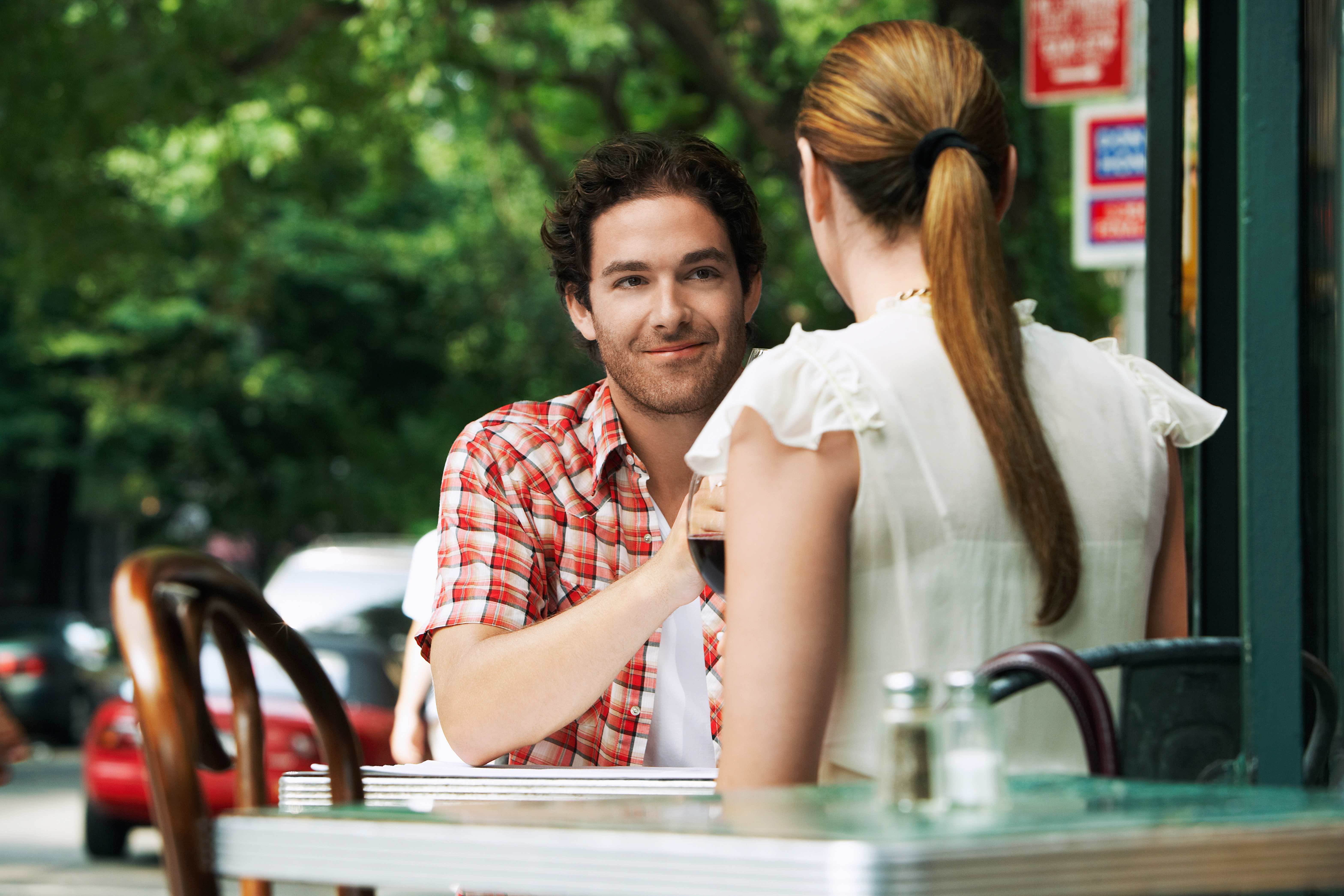Couple,Sitting,At,Sidewalk,Cafe