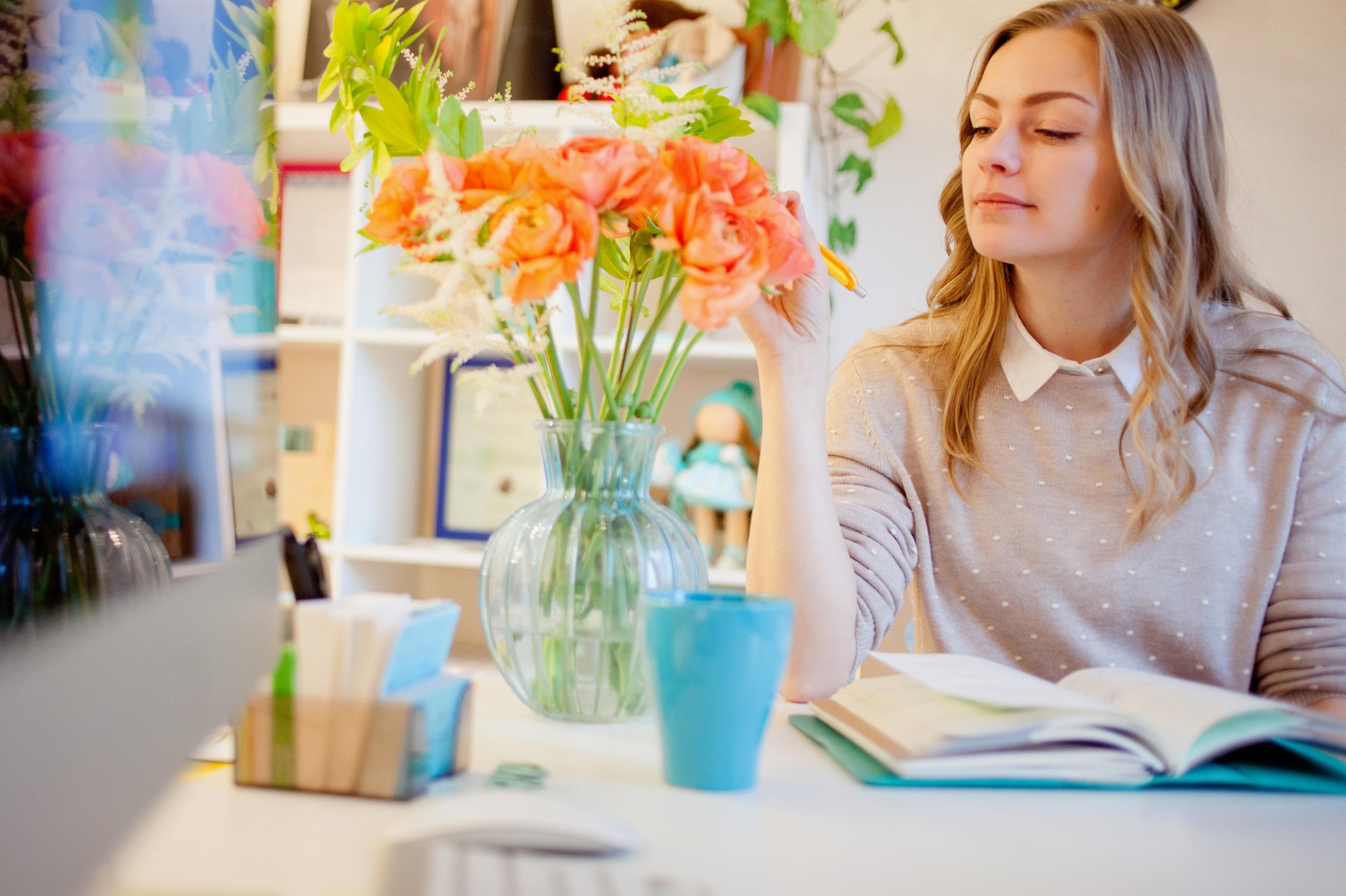 Young businesswoman sitting at desk and working. Beautiful woman and her workplace