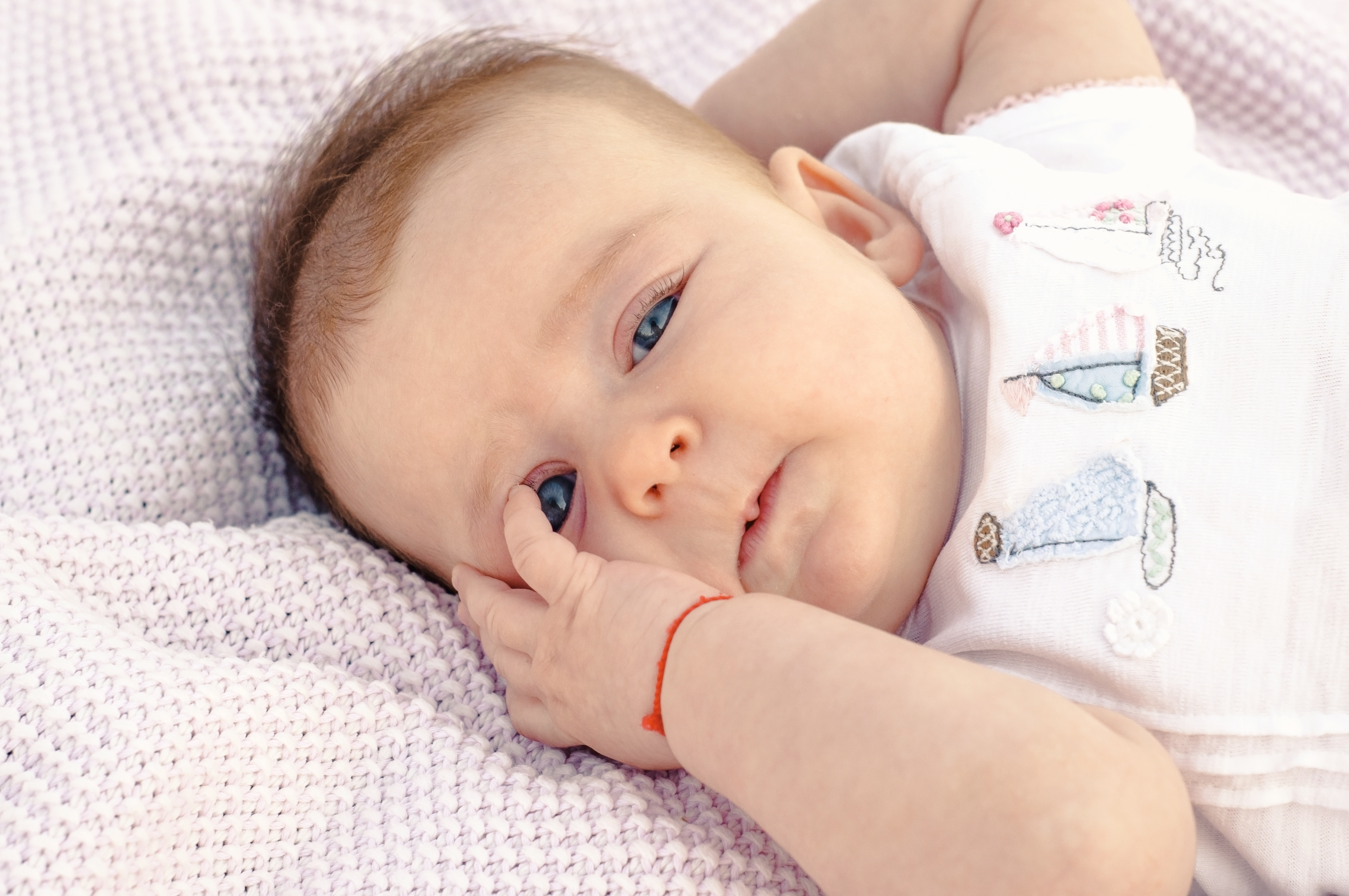 A,Newborn,Baby,With,A,Red,String,On,The,Wrist