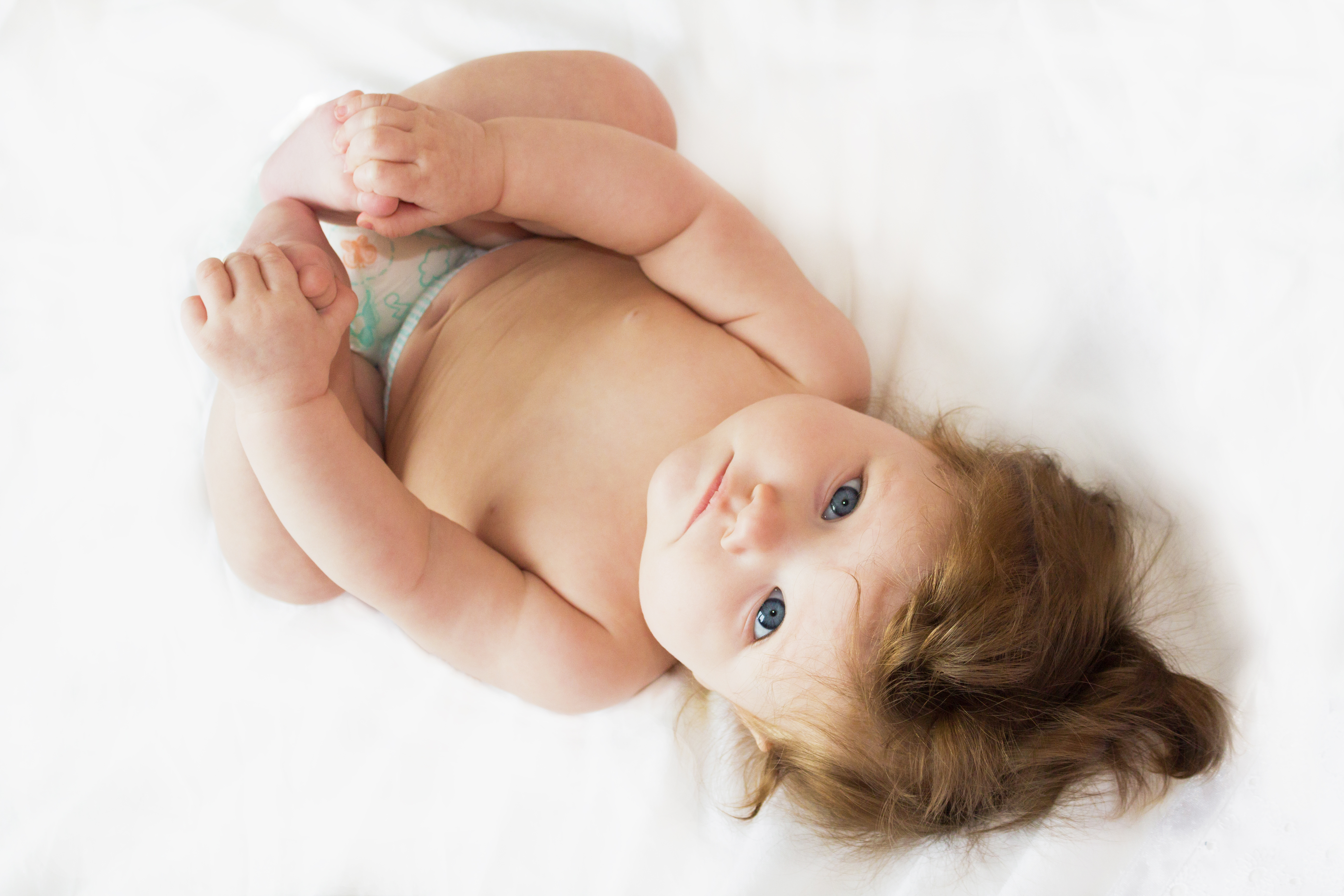 Funny,Beautiful,Little,Baby,Lying,On,A,White,Diaper.