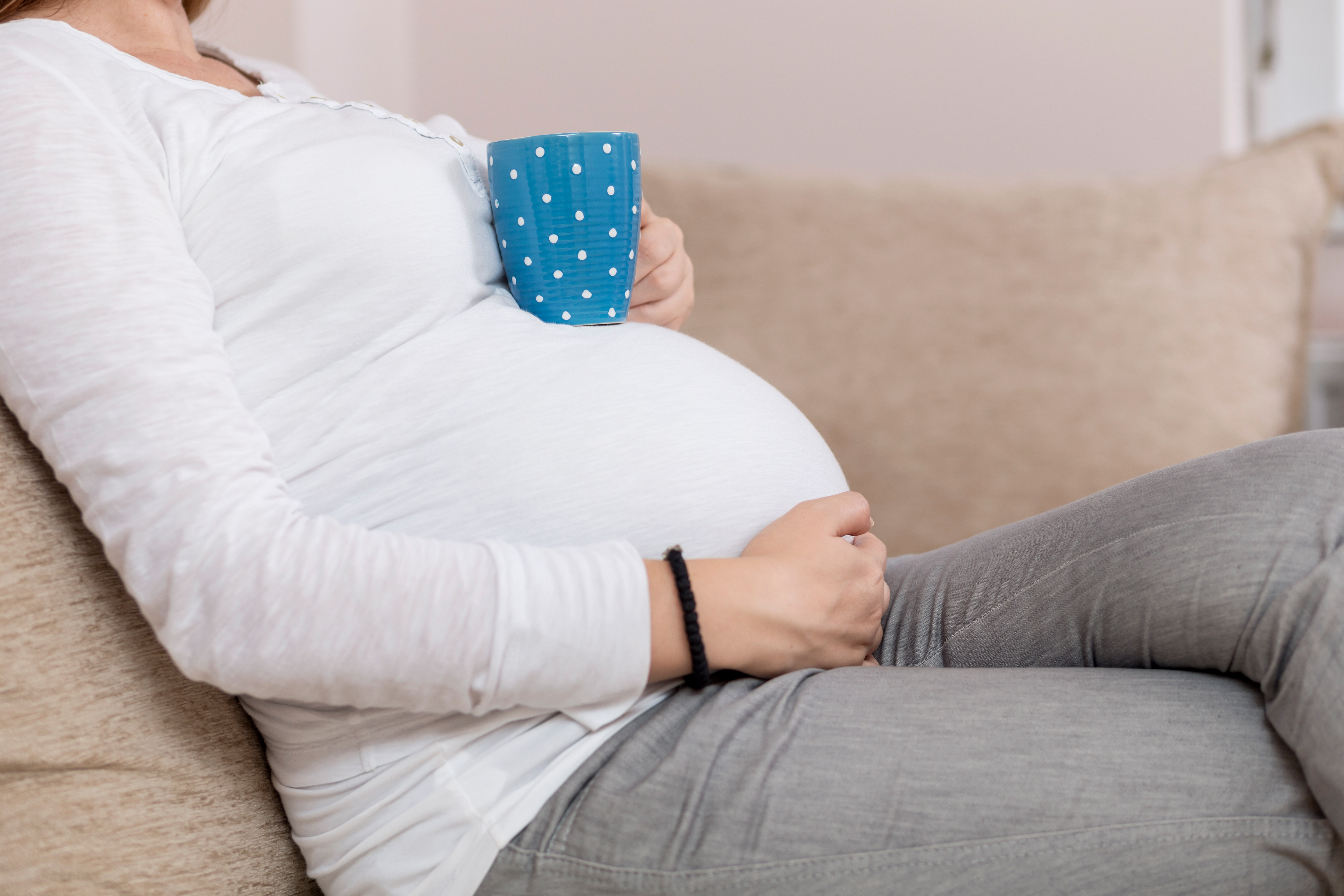 Detail,Of,A,Pregnant,Woman's,Body.,Pregnant,Woman,Sitting,On