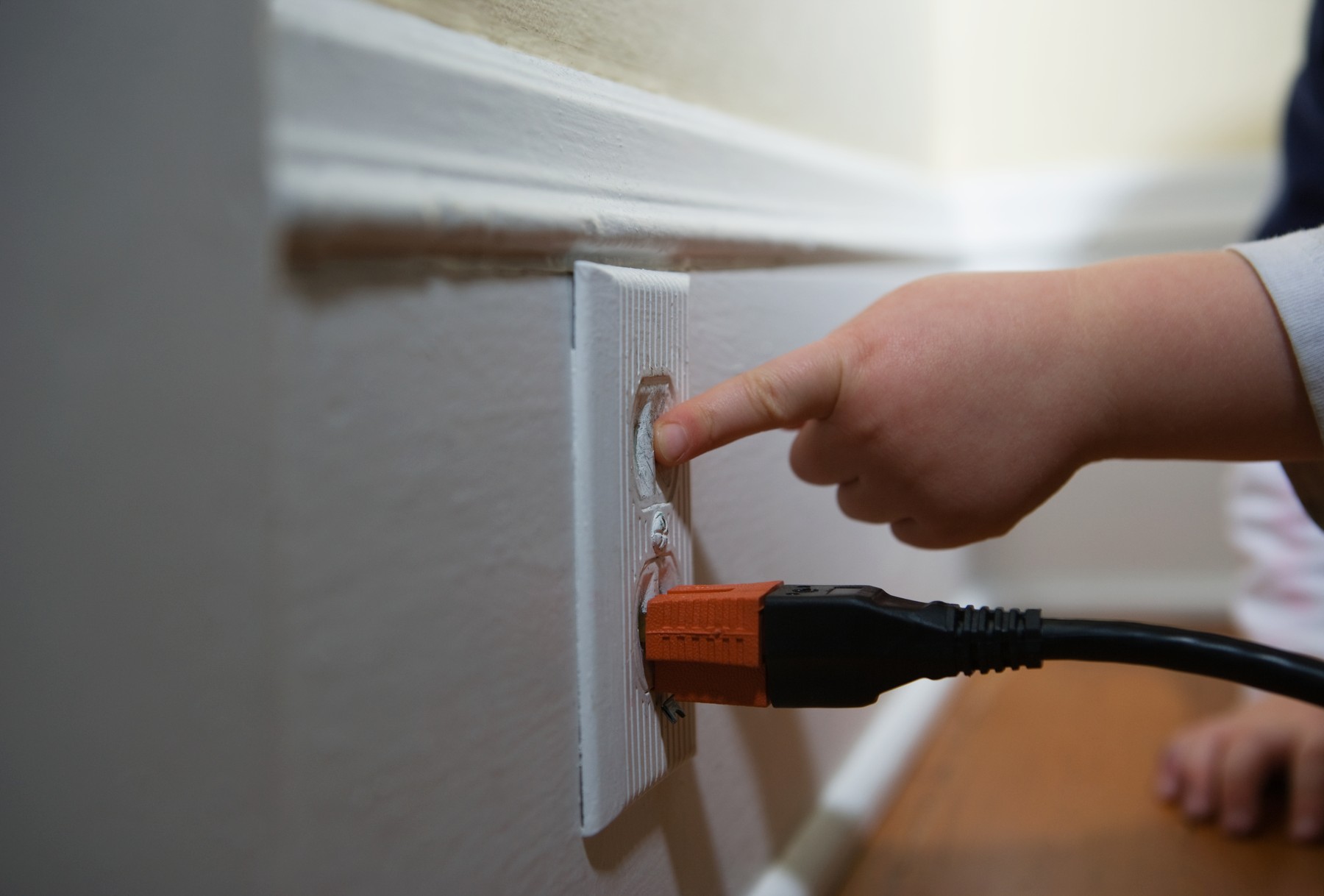 Child poking electrical plug