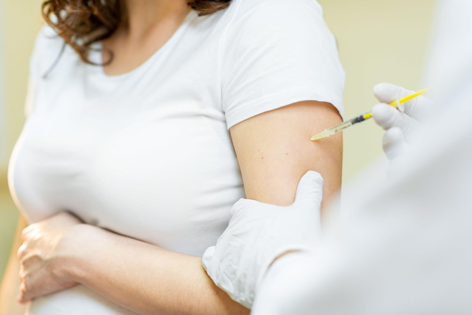 Vaccine injection procedure for a pregnant woman, cropped view without face