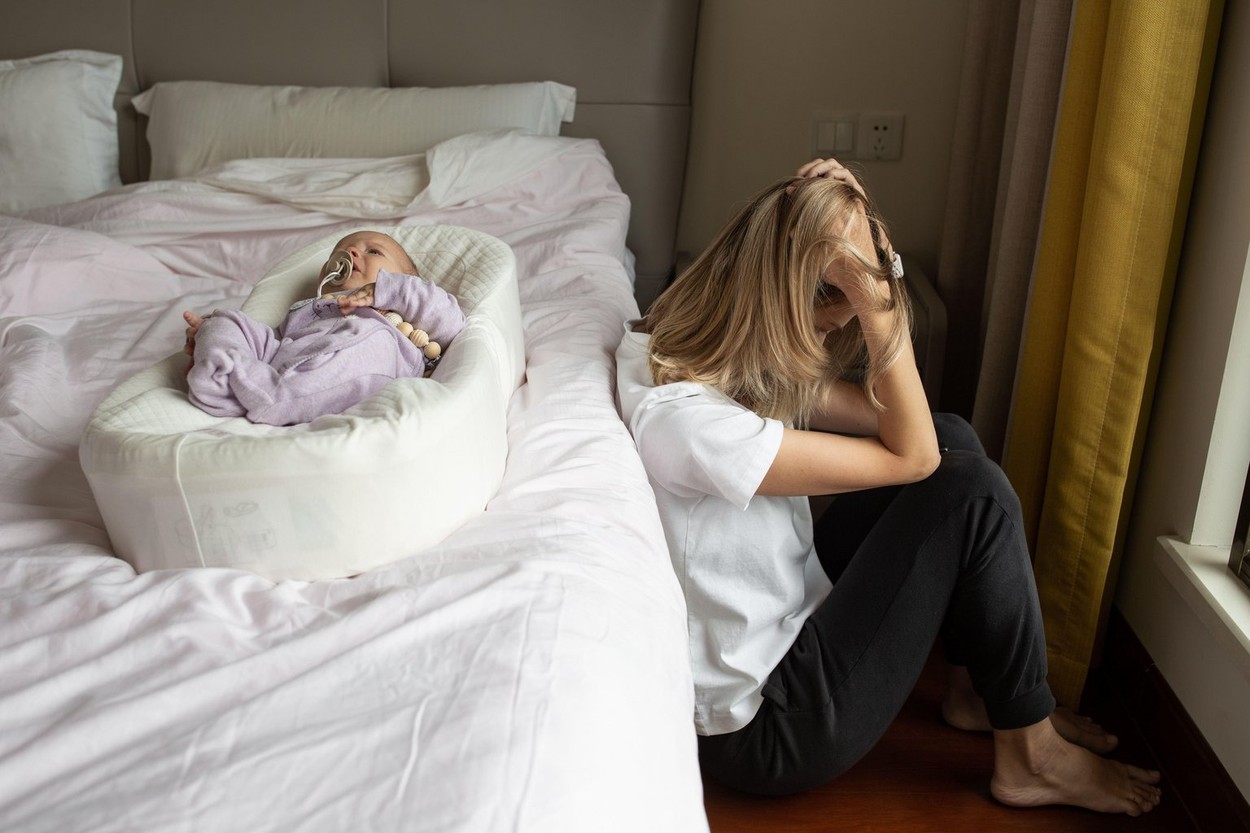 Tired Mother Suffering from experiencing postnatal depression. Health care mom motherhood stressful. Stay at home during coronavirus covid-19 pandemic