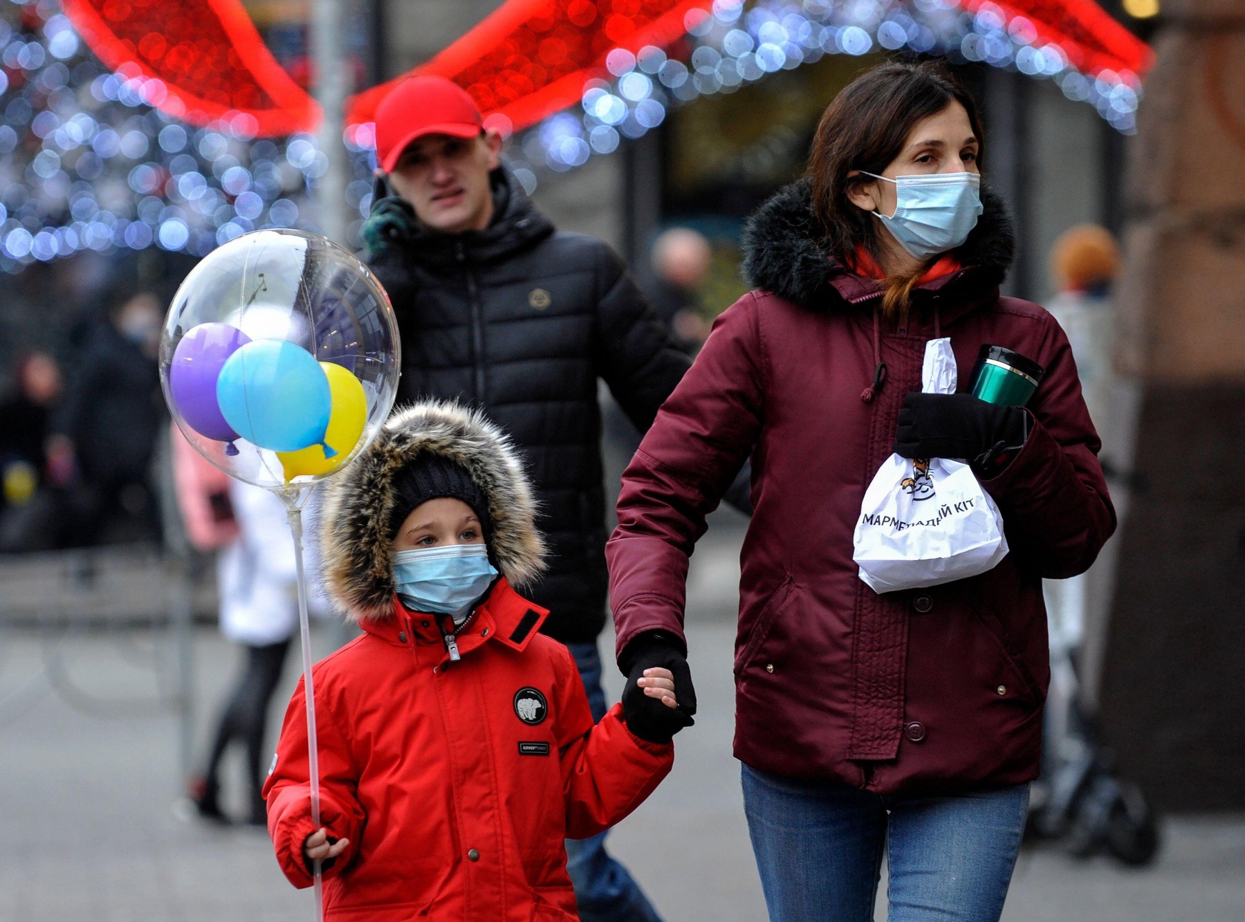 A mother and child wearing face masks as a precaution against the spread of Coronavirus walk on the street during the coronavirus crisis.The Ukrainian government has introduced new restrictions to prevent the spread of COVID-19. They will be valid from Ja