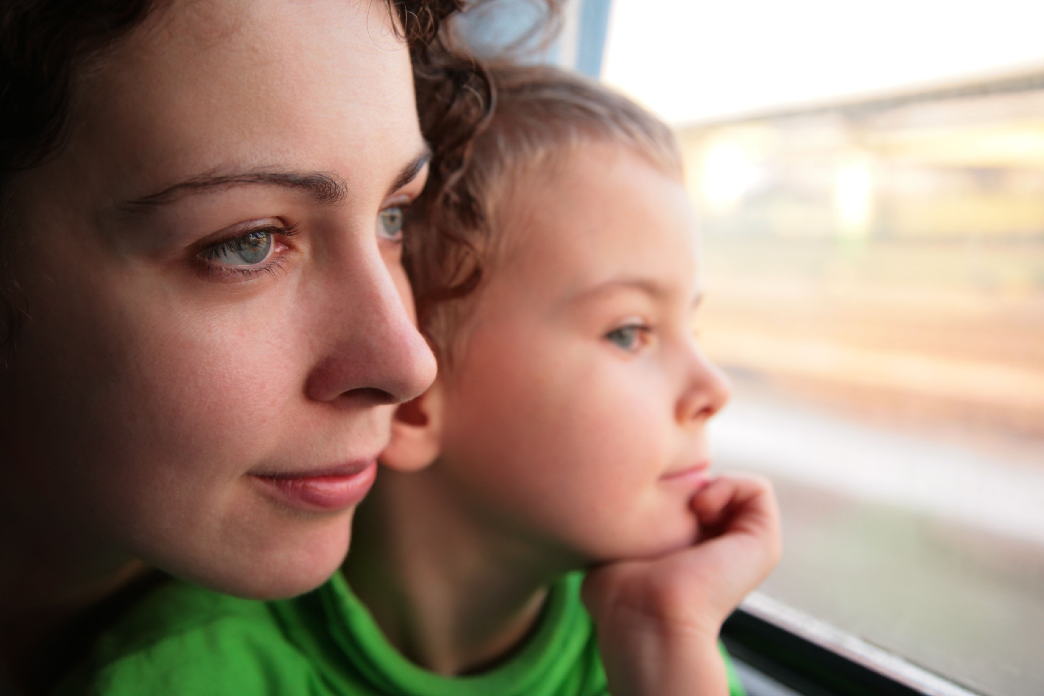 mother and son look in train`s window