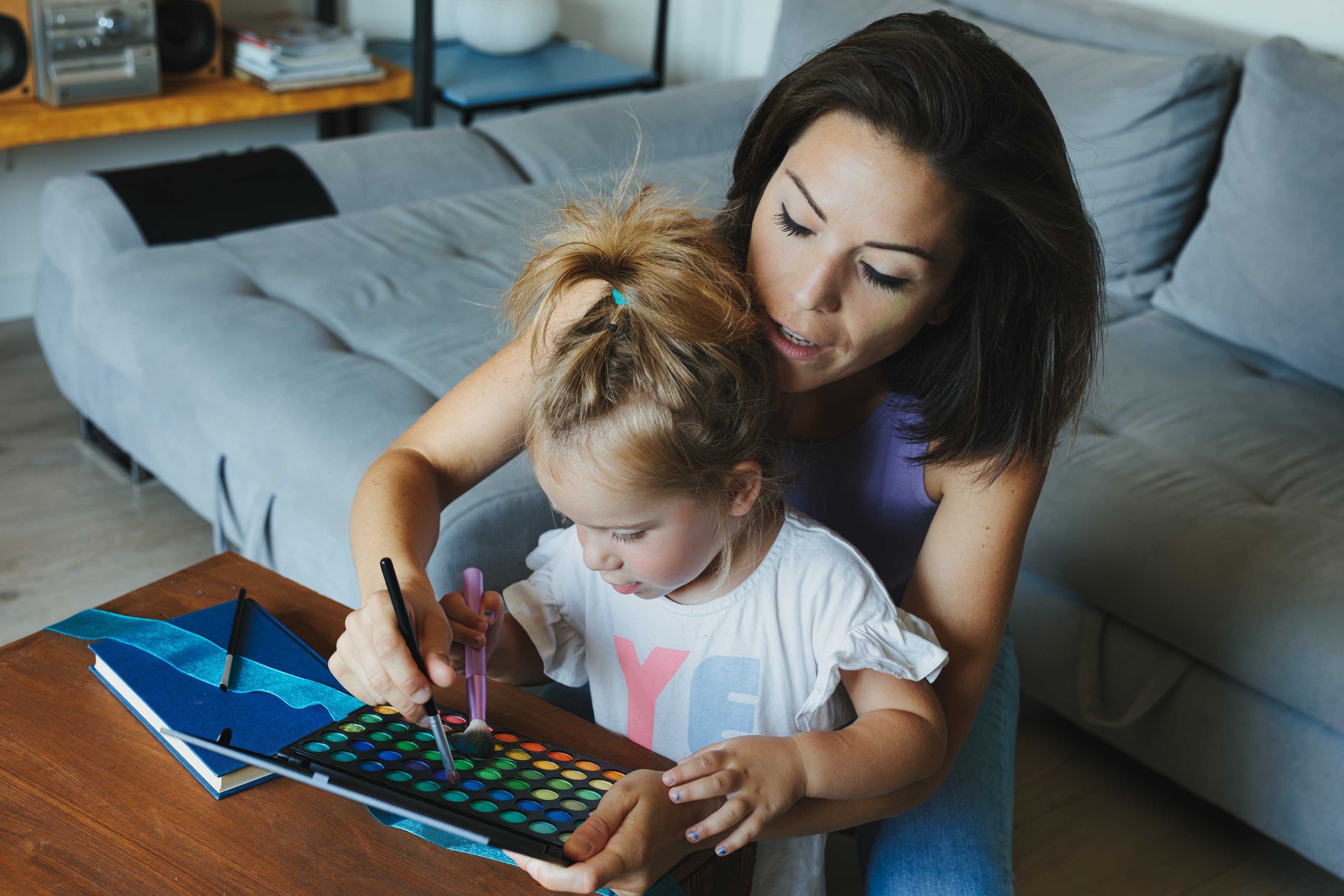 Mother, child in living room, play with makeup