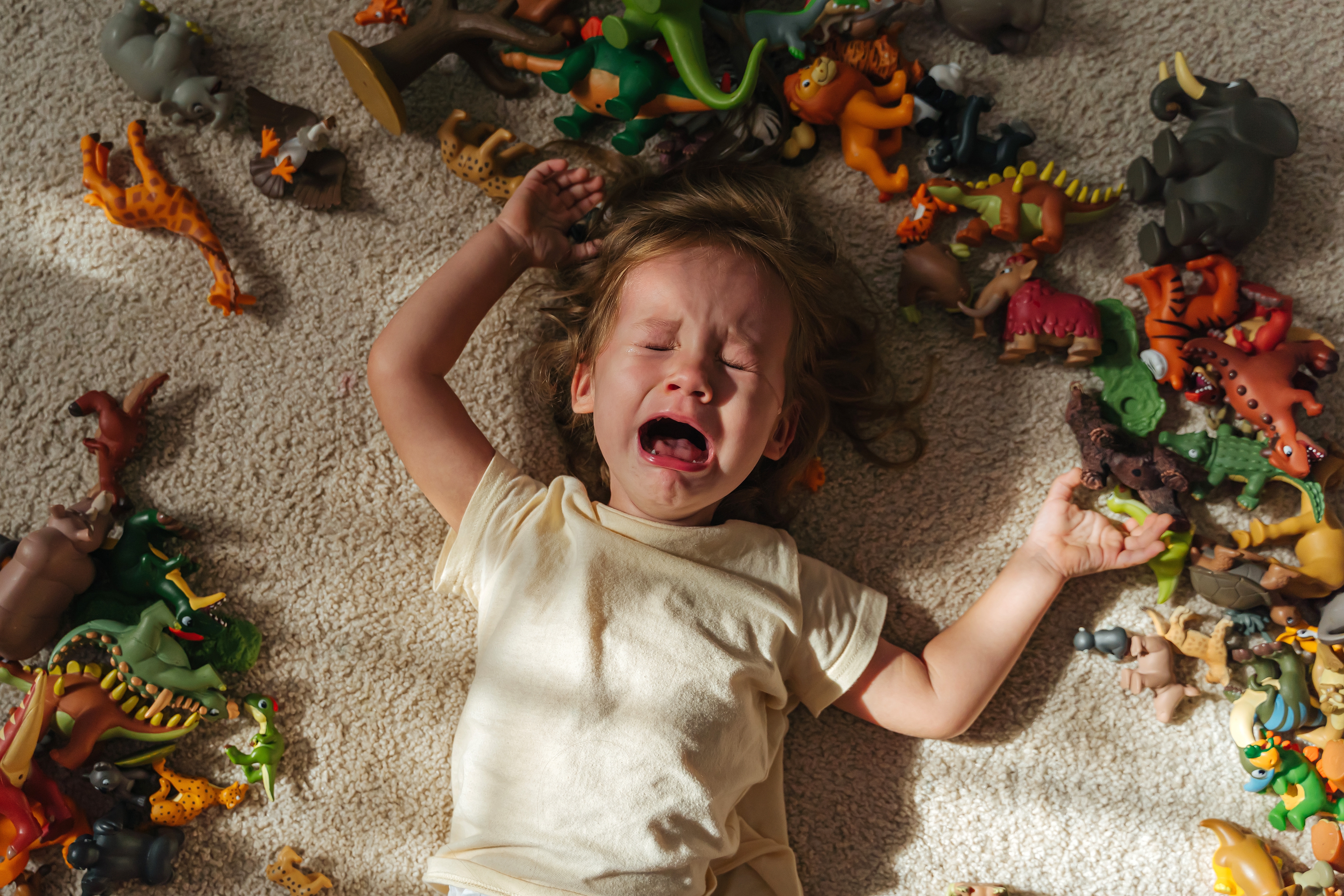 Toddler,Cries,And,Is,Naughty,Lying,On,The,Floor,Among