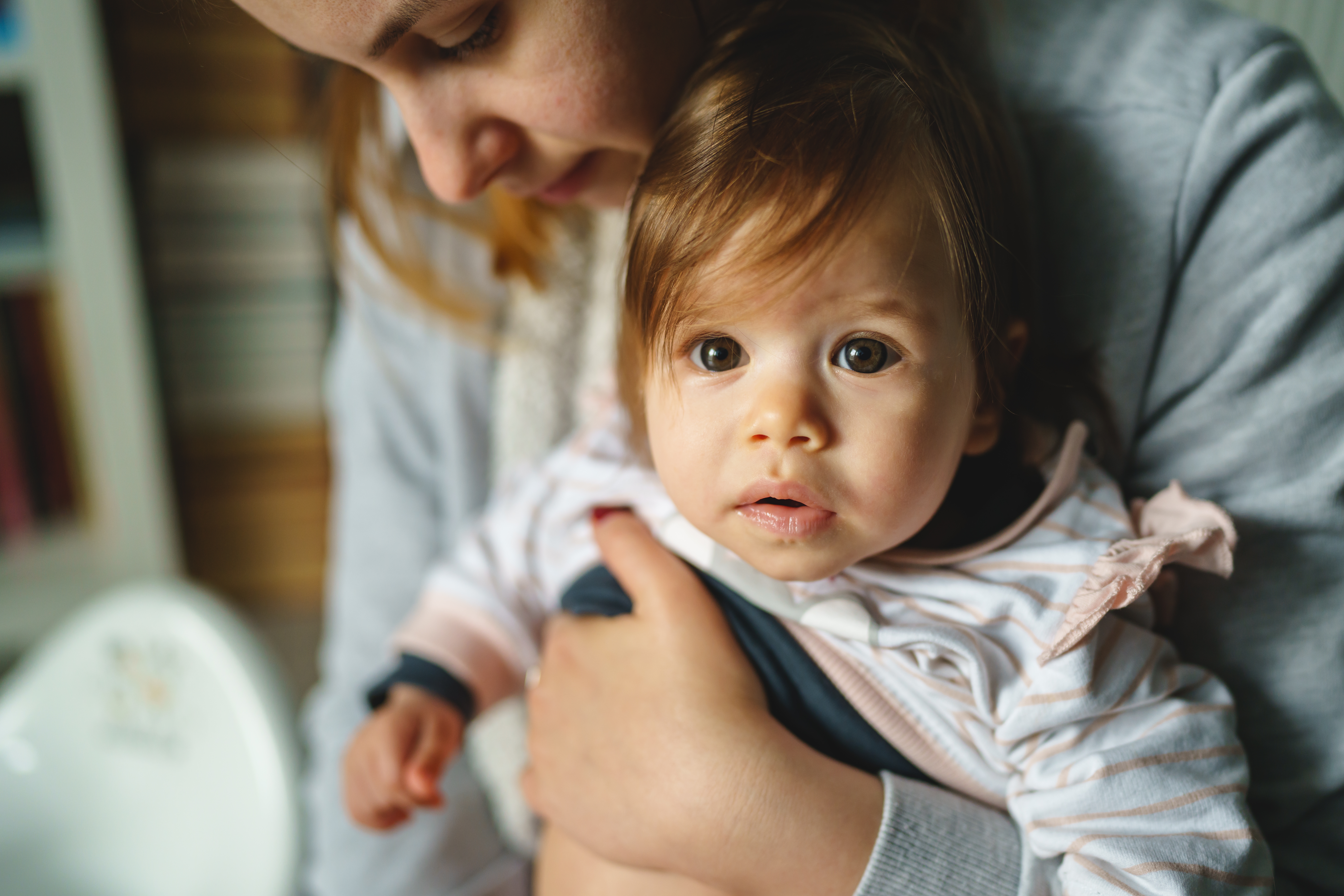 Small,Caucasian,Baby,In,Hands,Of,Her,Mother,Sitting,And