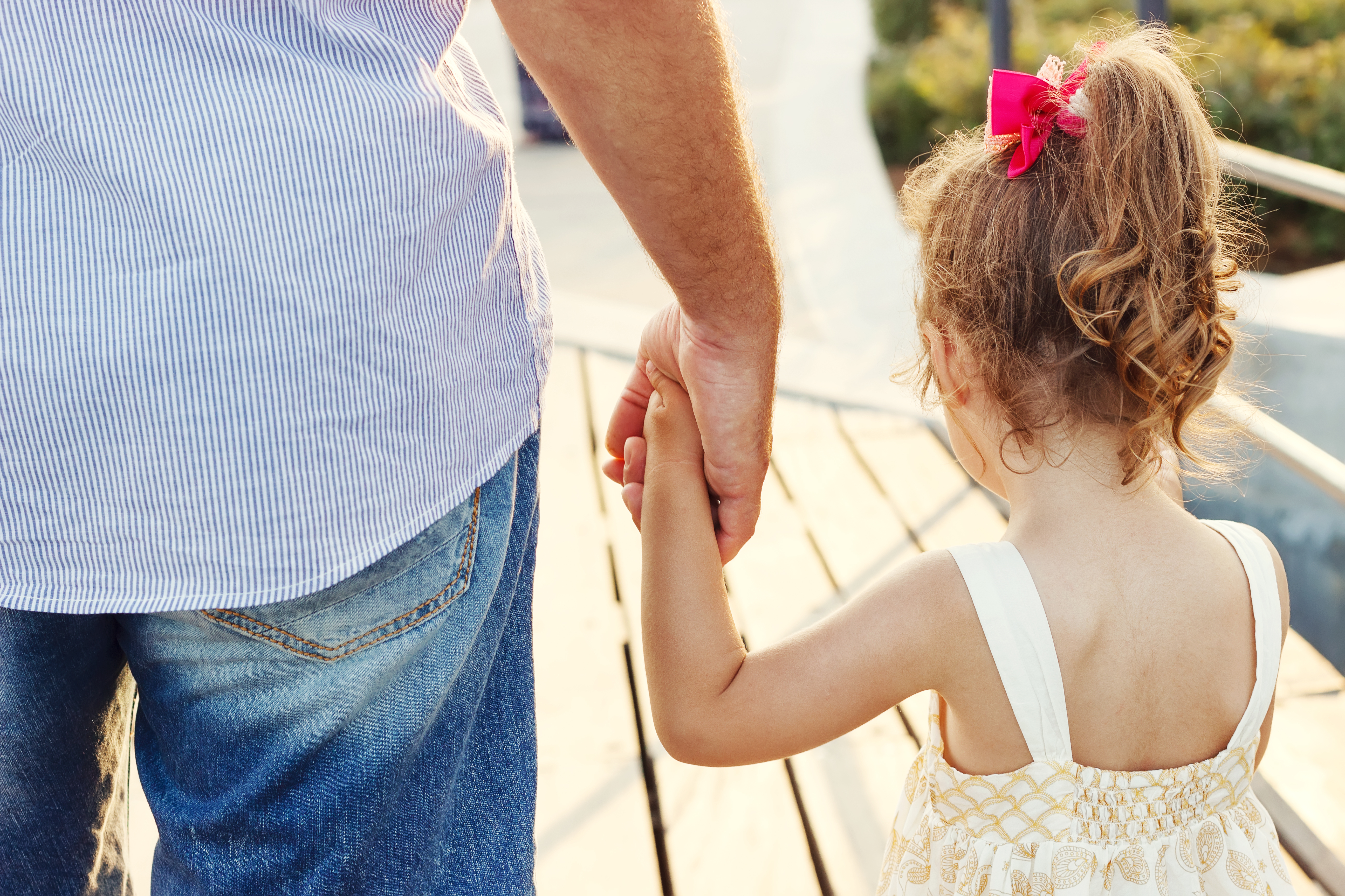 Father,And,Daughter,Holding,Hand,In,Hand,At,Sunset