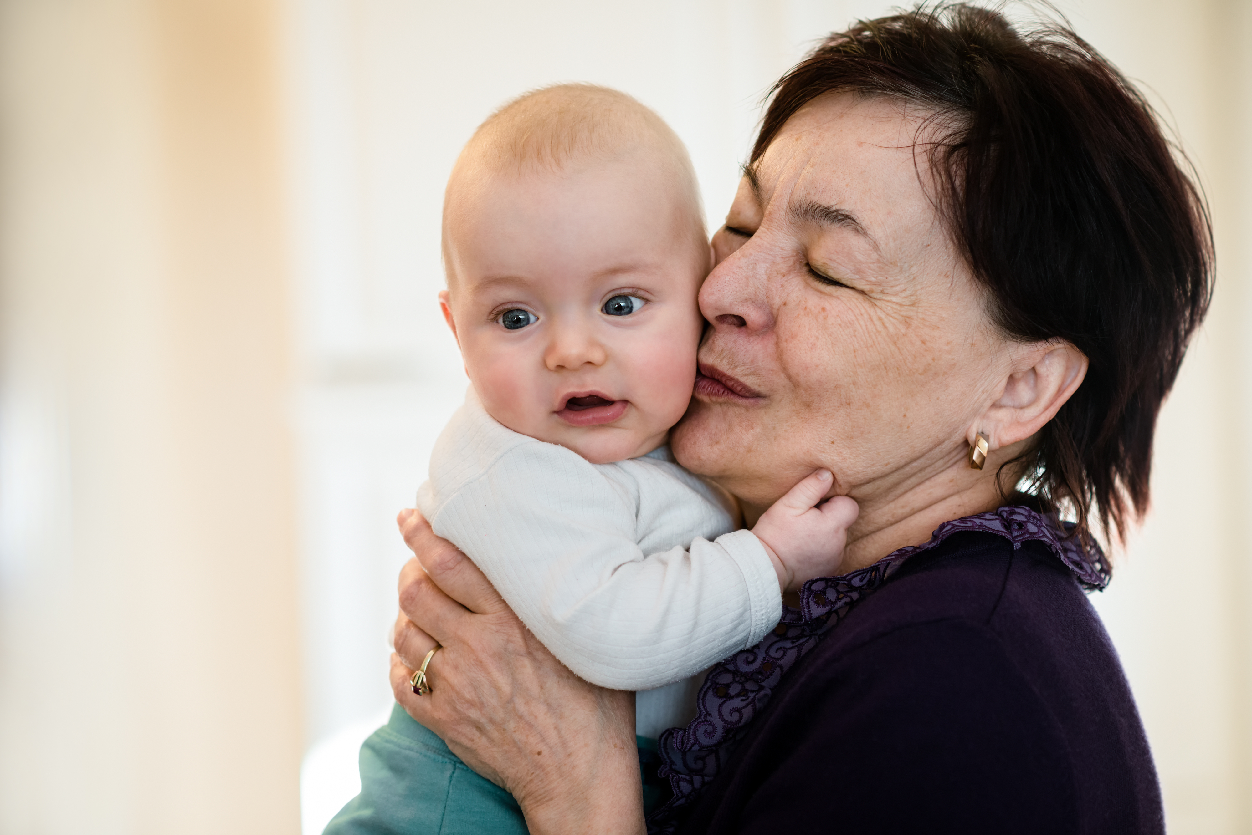 Grandmother,Is,Kissing,Her,Baby,Grandson,-,Indoors,Scene