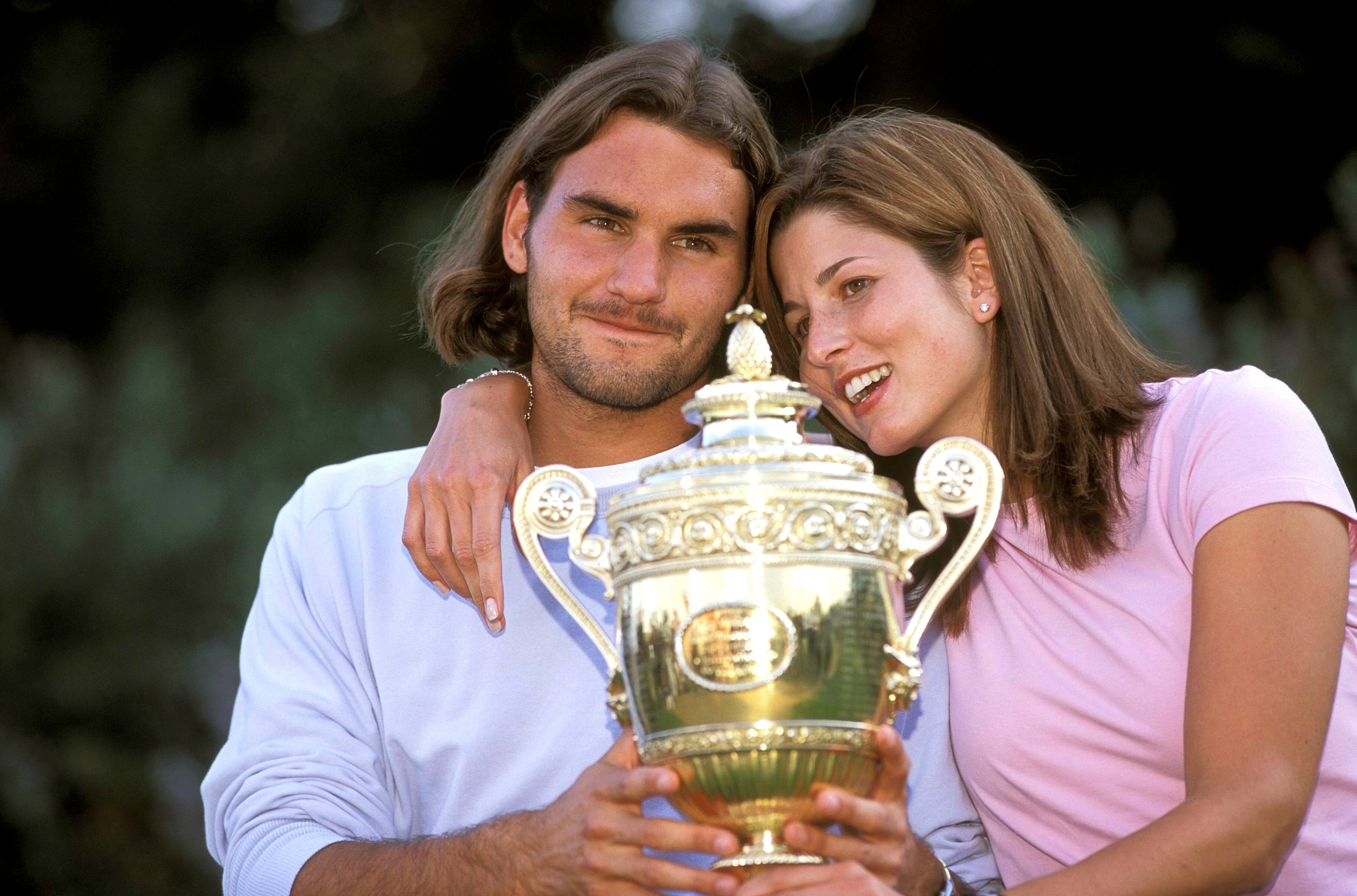 File photos - Roger Federer and his girlfriend with the Wimbledon Trophy in London
