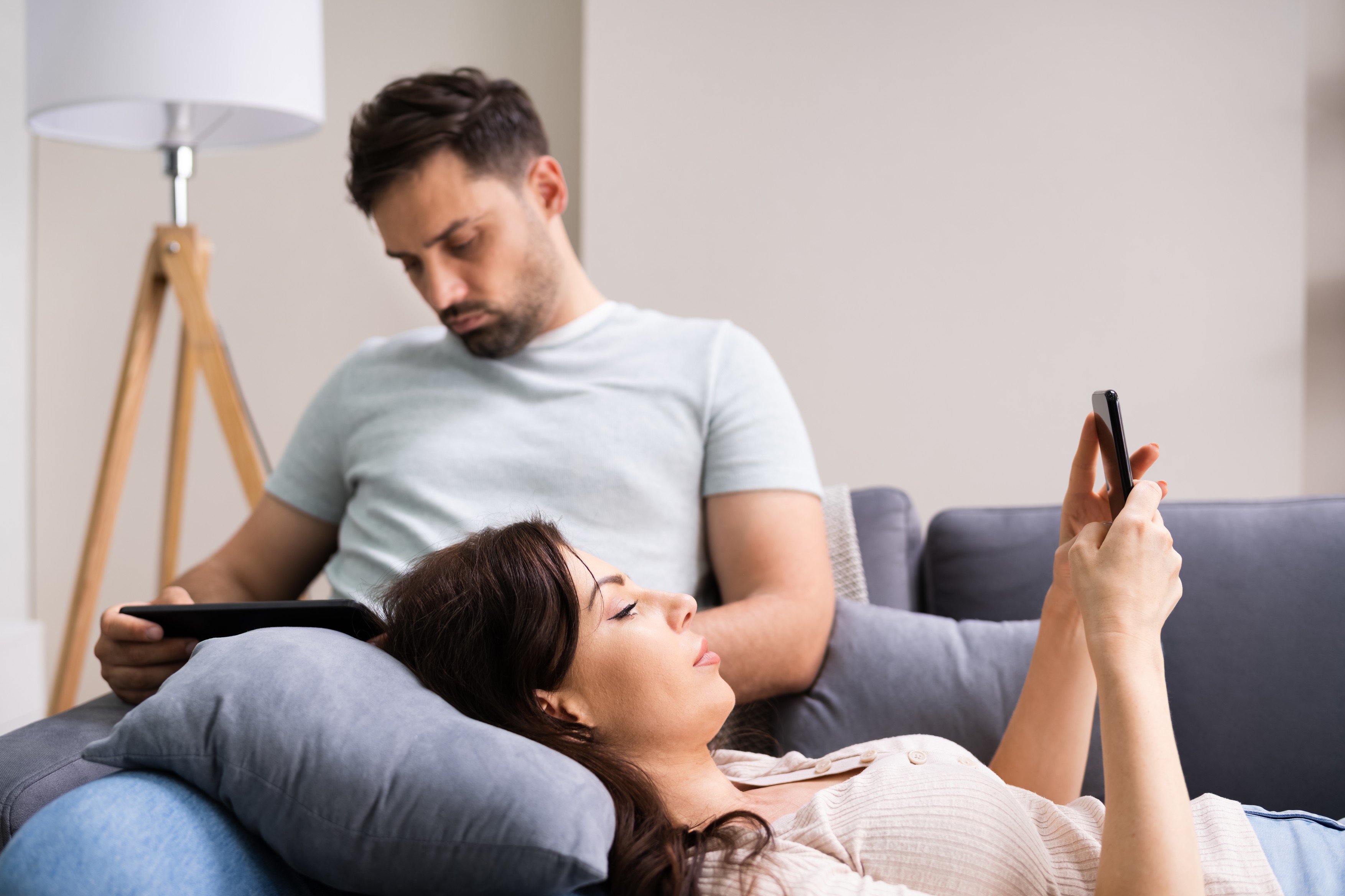 Family Couple Using Tablet And Phone
