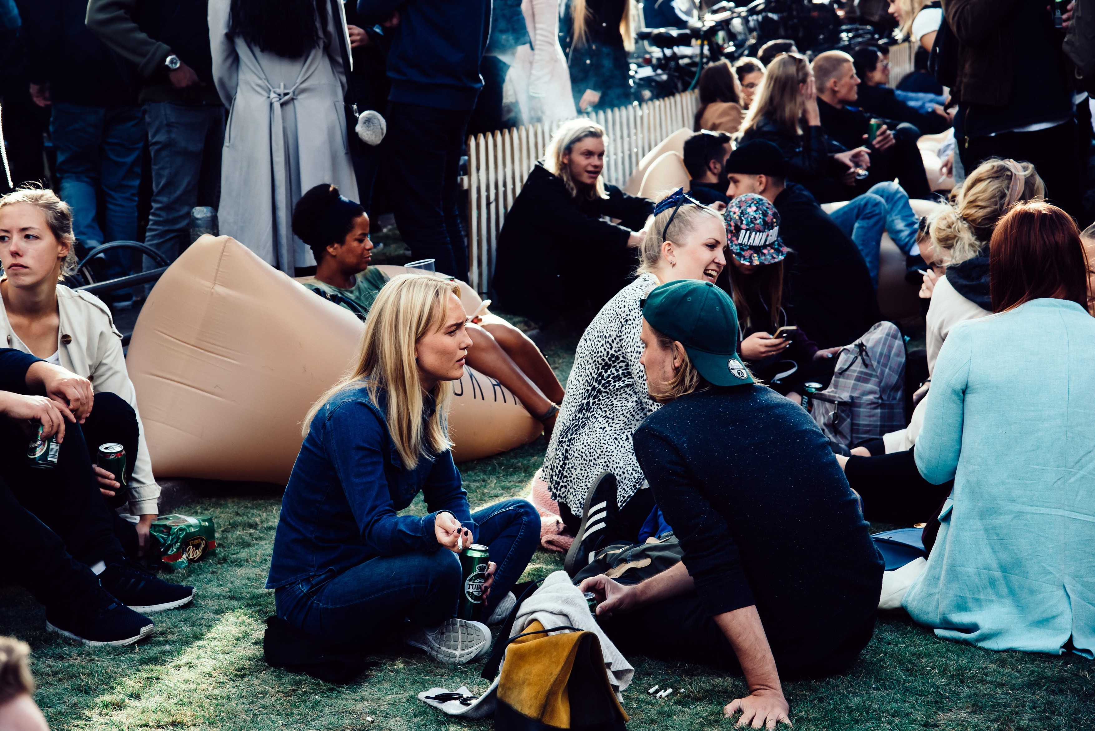 Copenhagen, Denmark - August 11, 2016. Crowd of young people sitting and enjoying in Kronprinsensgade, a street in the Old Town of Copenhagen, Denmark