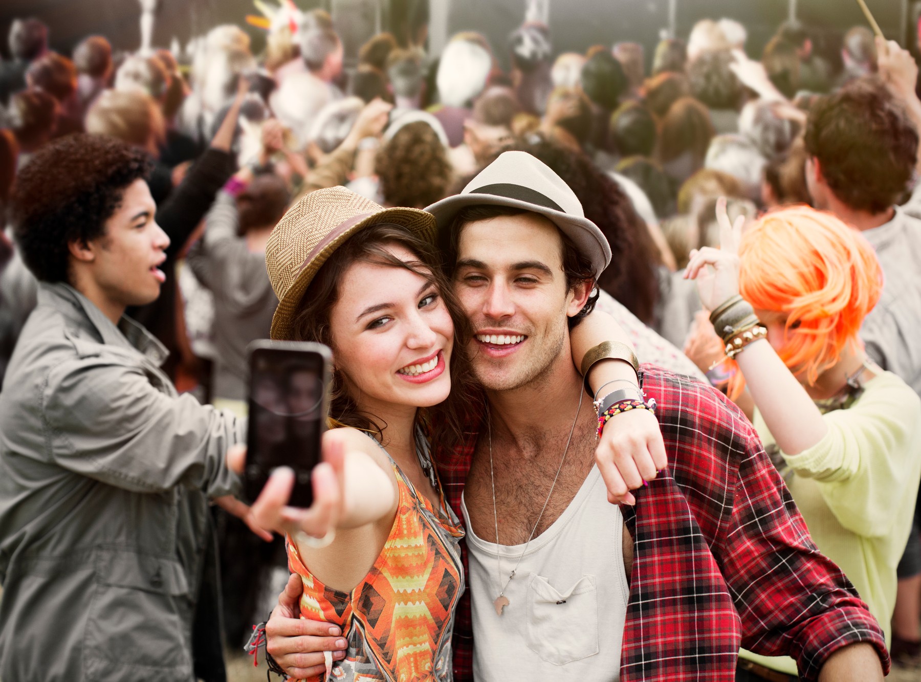 Couple taking self-portrait at music festival