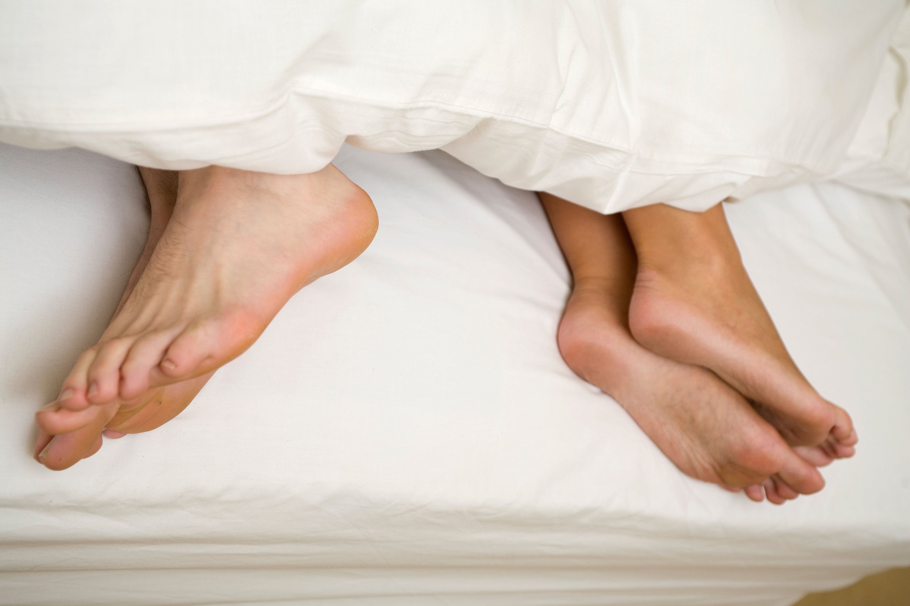 Couple in bed facing away from each other