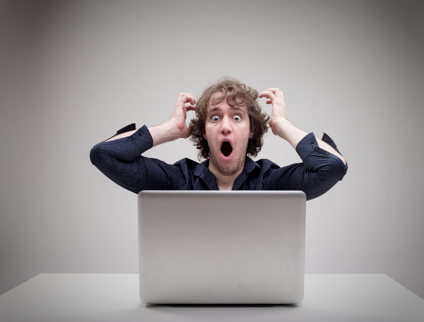 businessman very shocked about something he just viewed or read on the internet or viruses or application problems