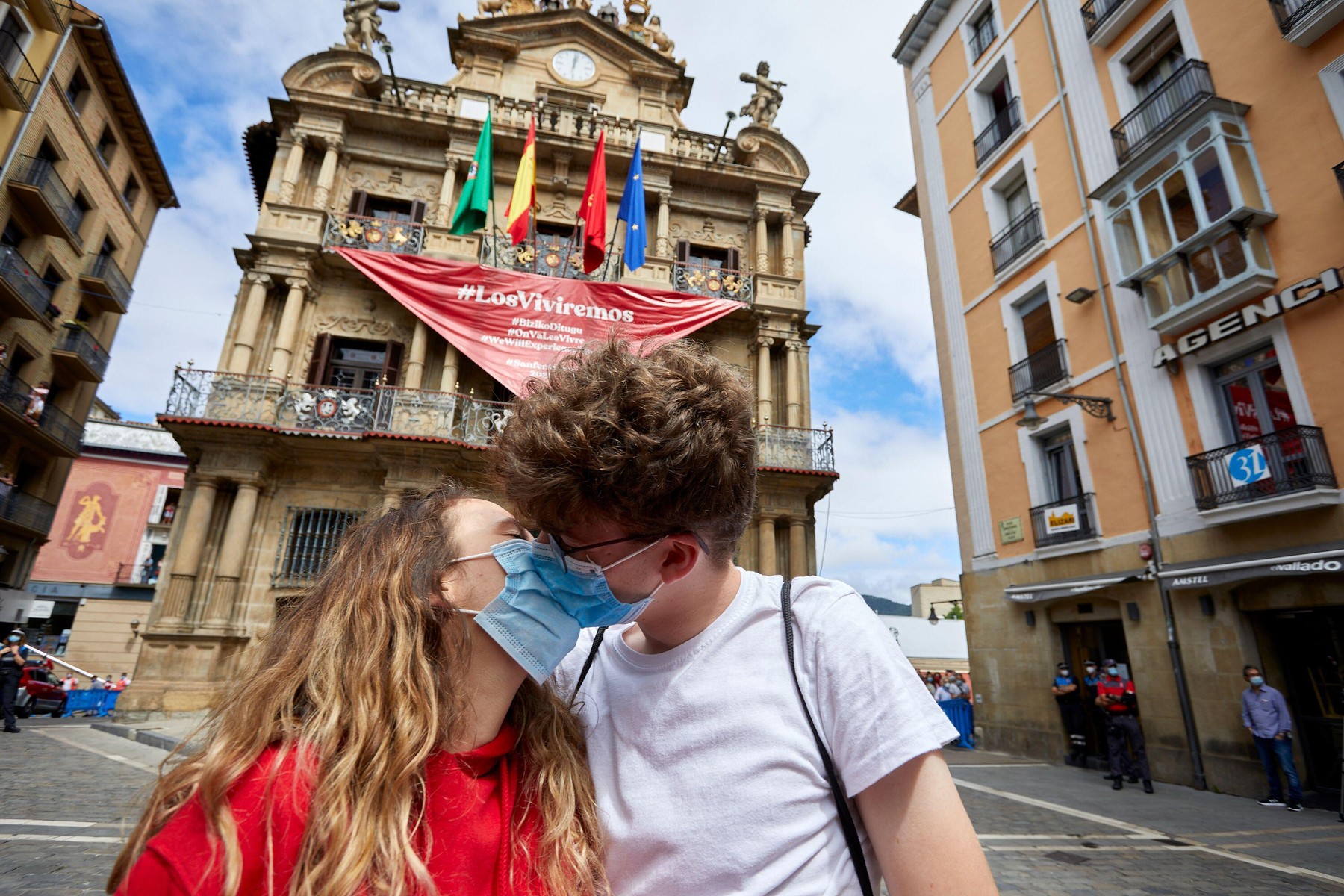 Pamplona. Spain. 6th Jul, 2020. A couple kisses in the Town Hall Square moments after the 'No Chupinazo' of this year. Despite the limited capacity and the strict security controls in the center of Pamplona, a group of people wanted to celebrate, in white