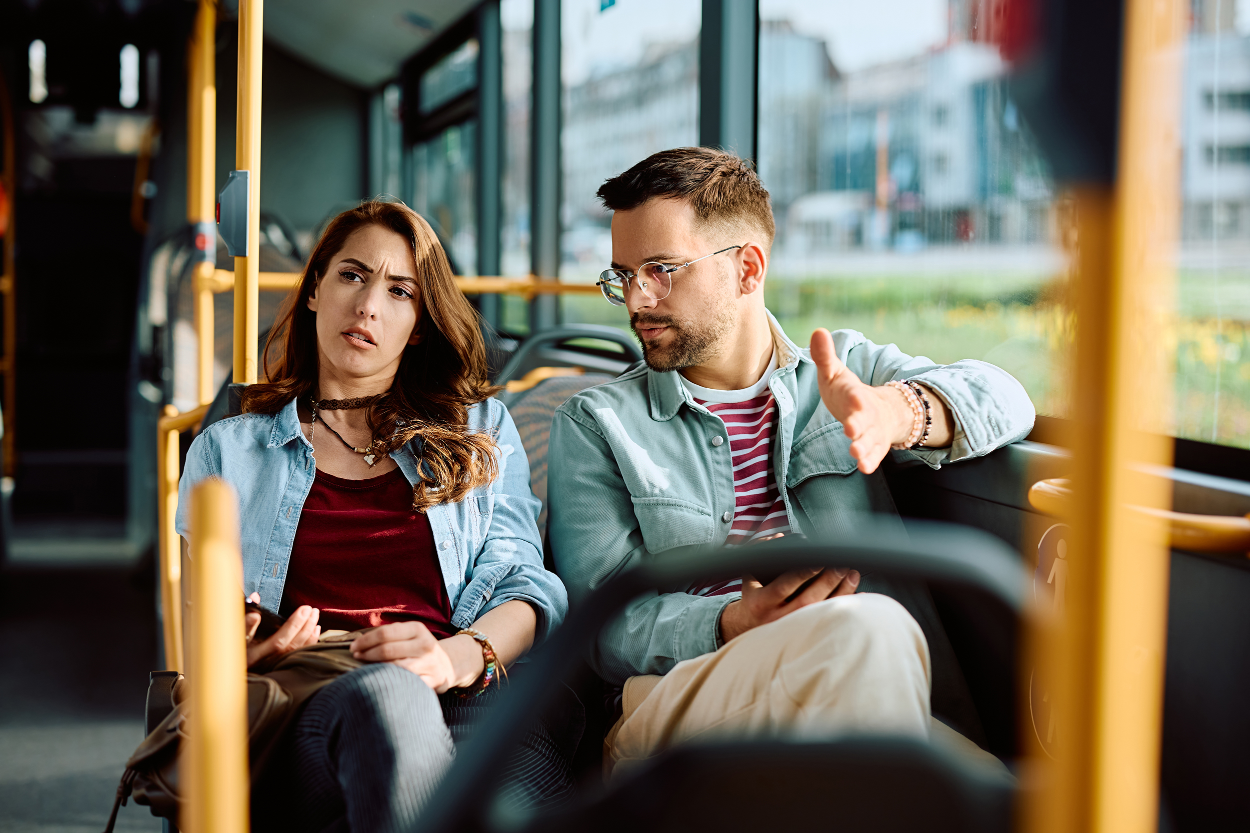 Young,Displeased,Couple,Communicating,While,Traveling,By,Public,Transport.