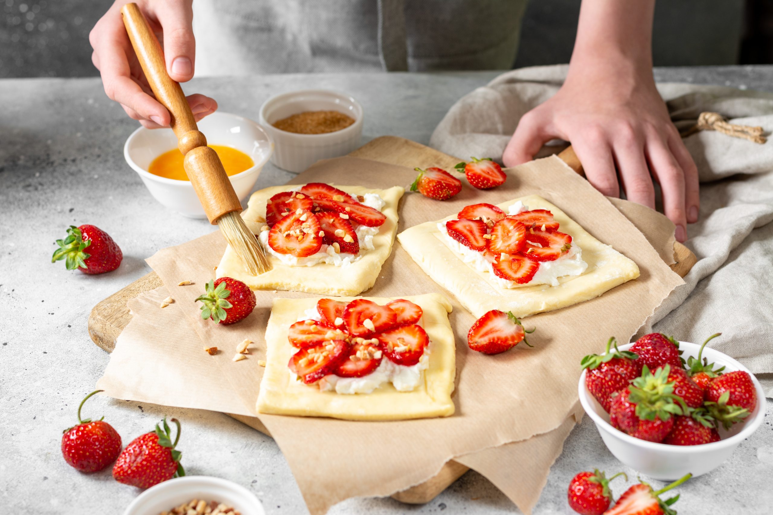 Raw,Puff,Pastry,With,Cheese,Cream,And,Strawberries.,The,Process