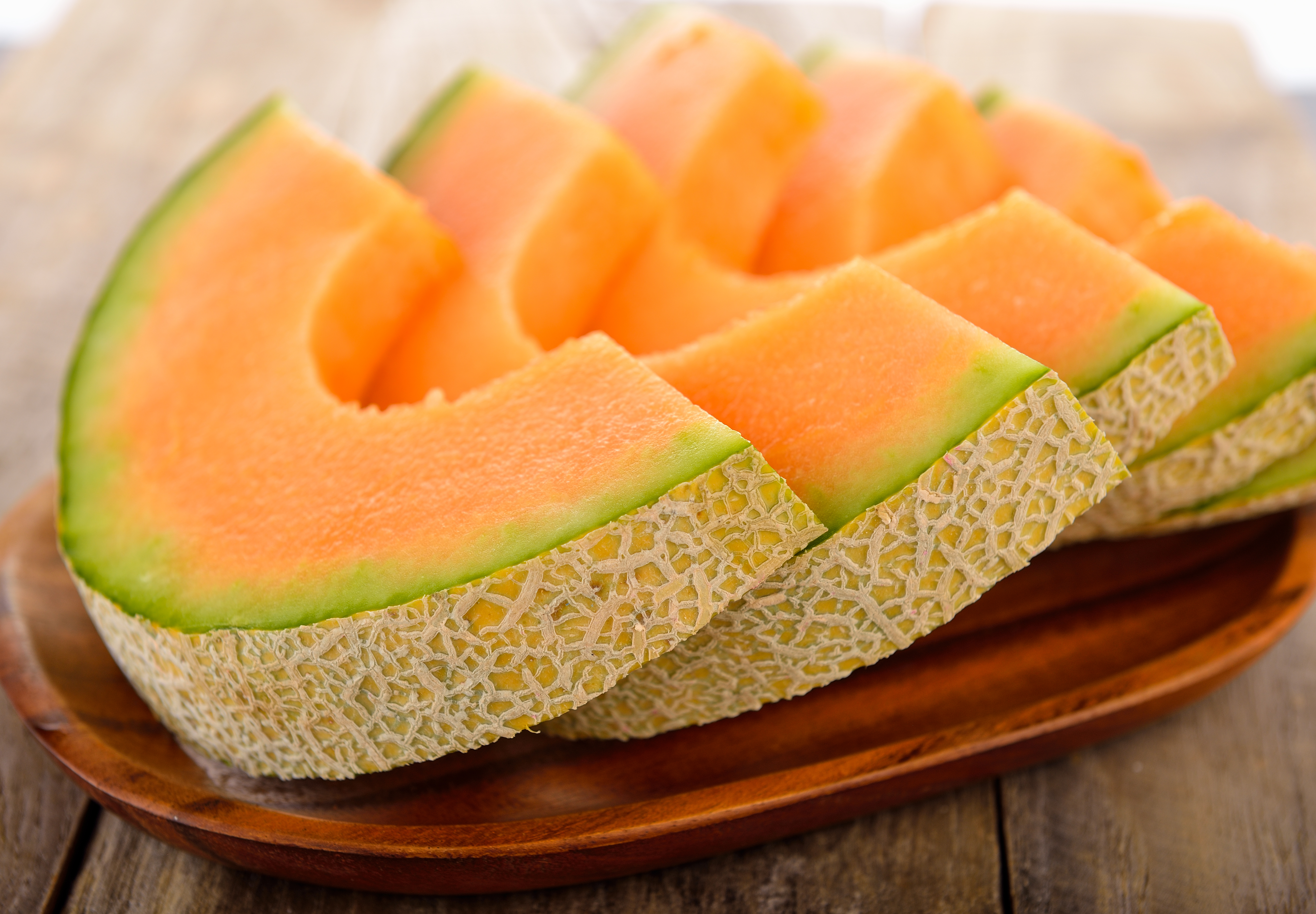Fresh,Melons,Sliced,On,Wooden,Plate