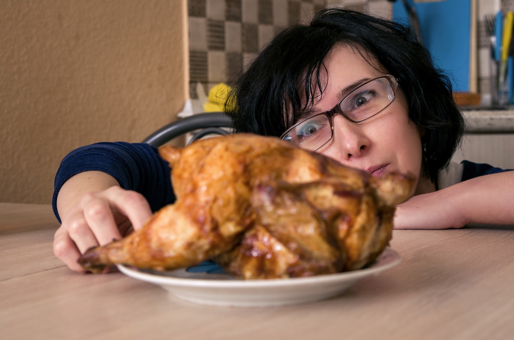 Funny hungry woman looking on the chicken