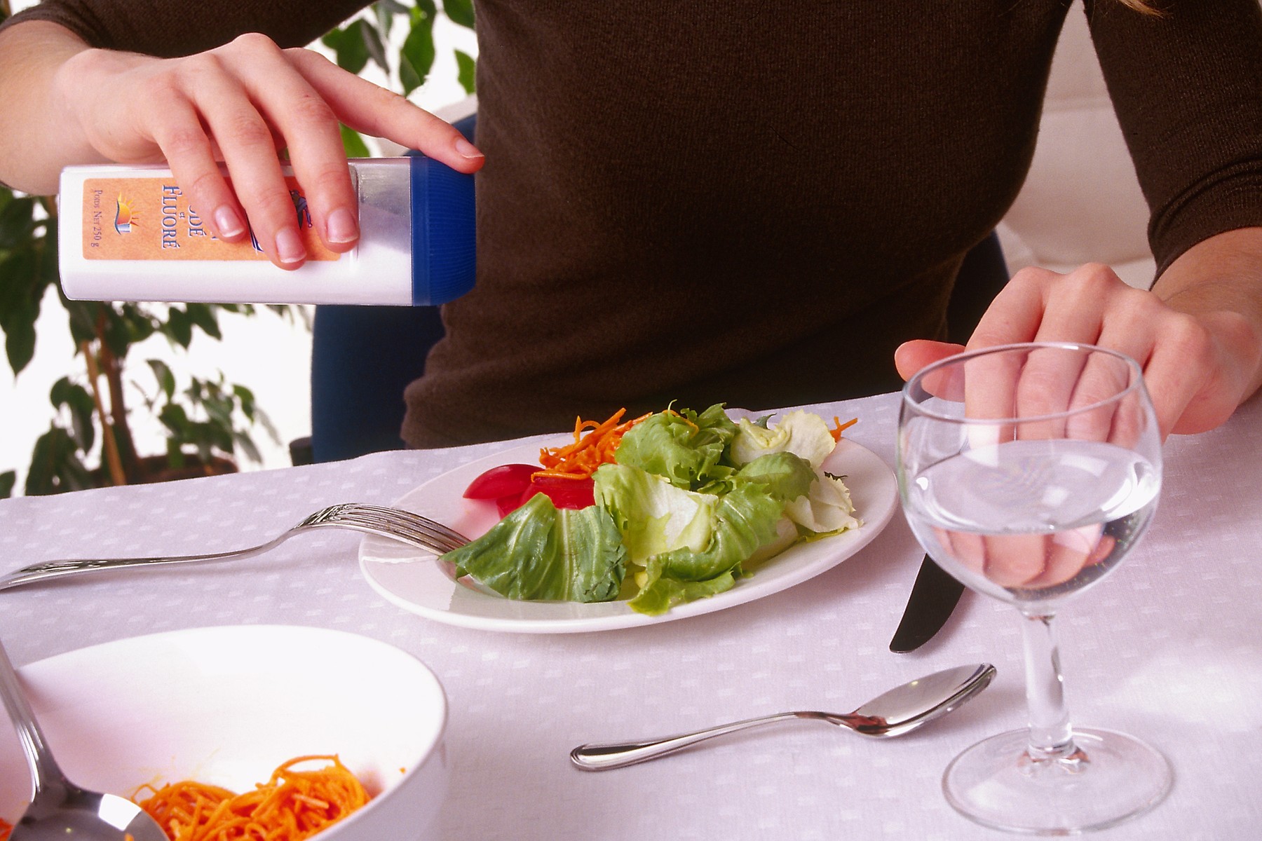 WOMAN EATING RAW VEGETABLES