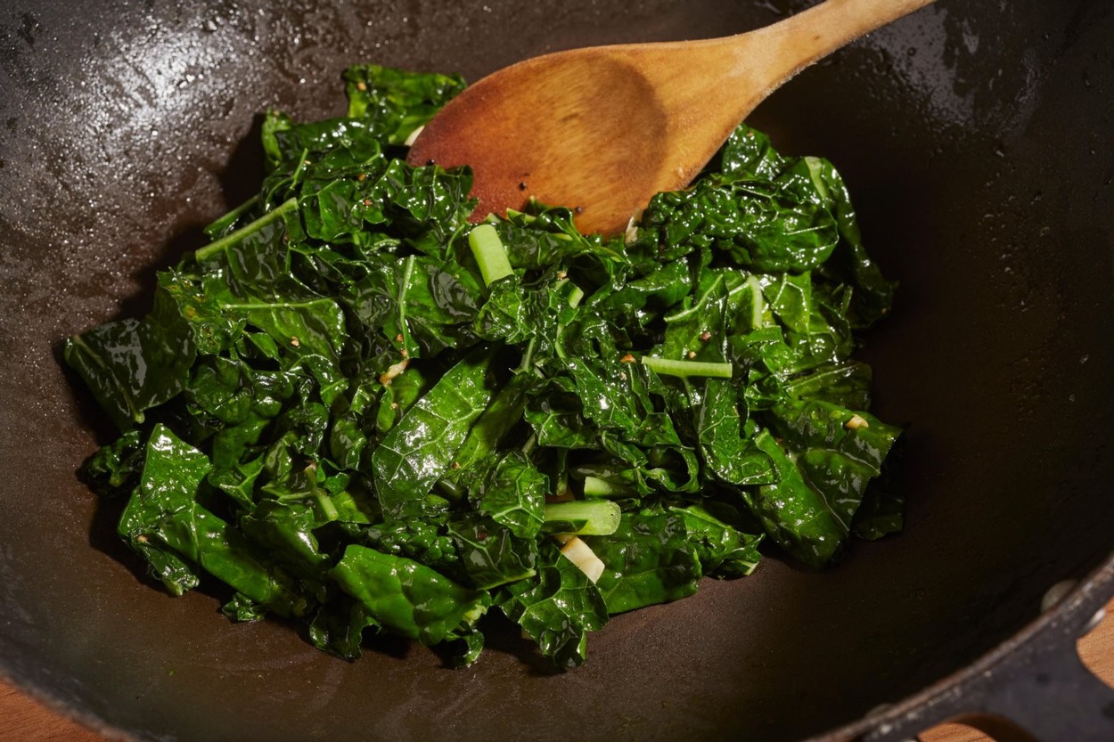 Tuscan Kale stir fried with garlic in a wok