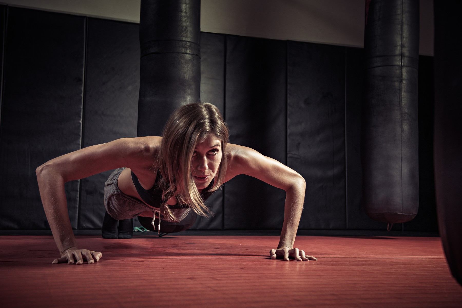 Woman doing push ups in gym