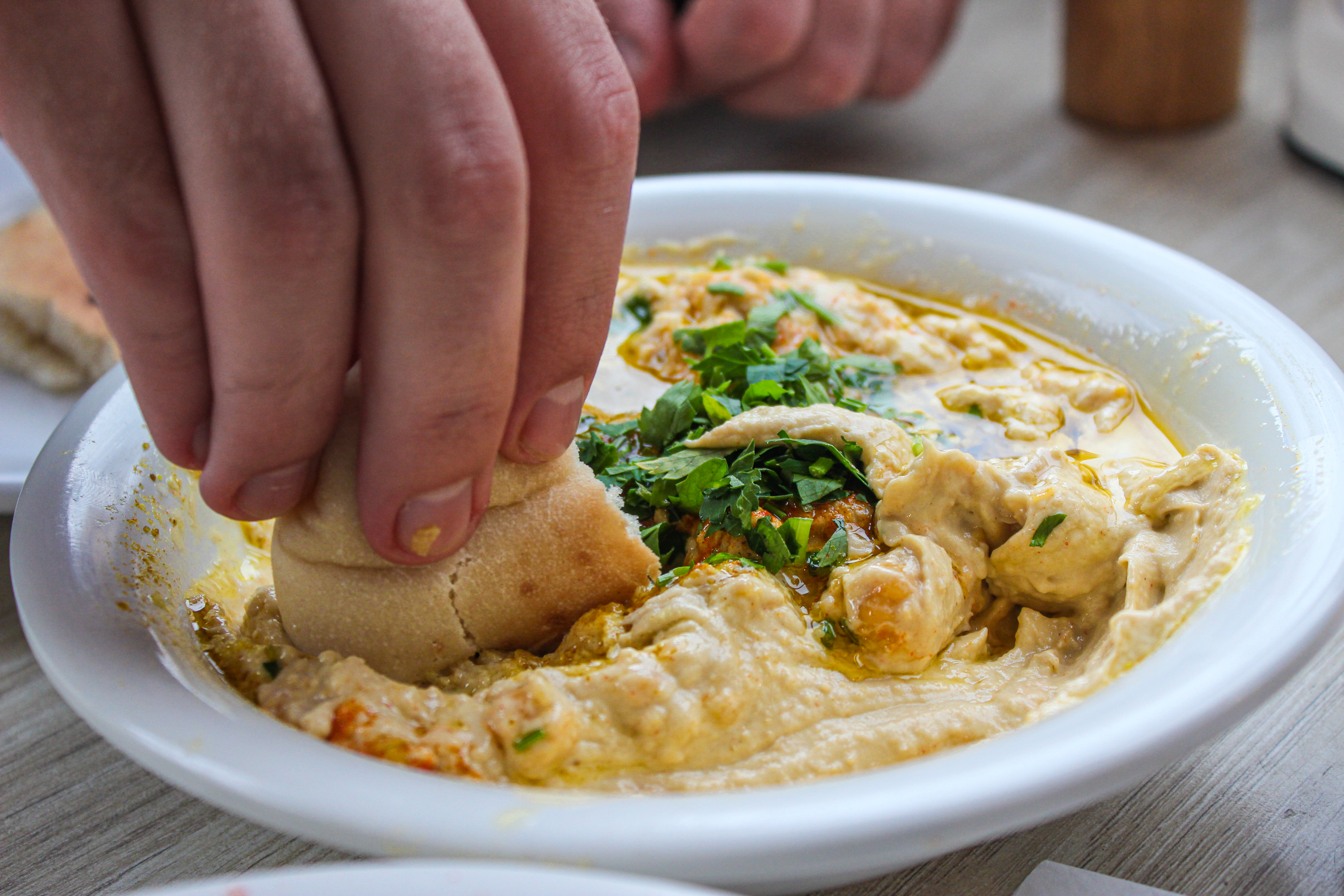 A,Man,Picks,Up,A,Pita,Hummus,In,Israel