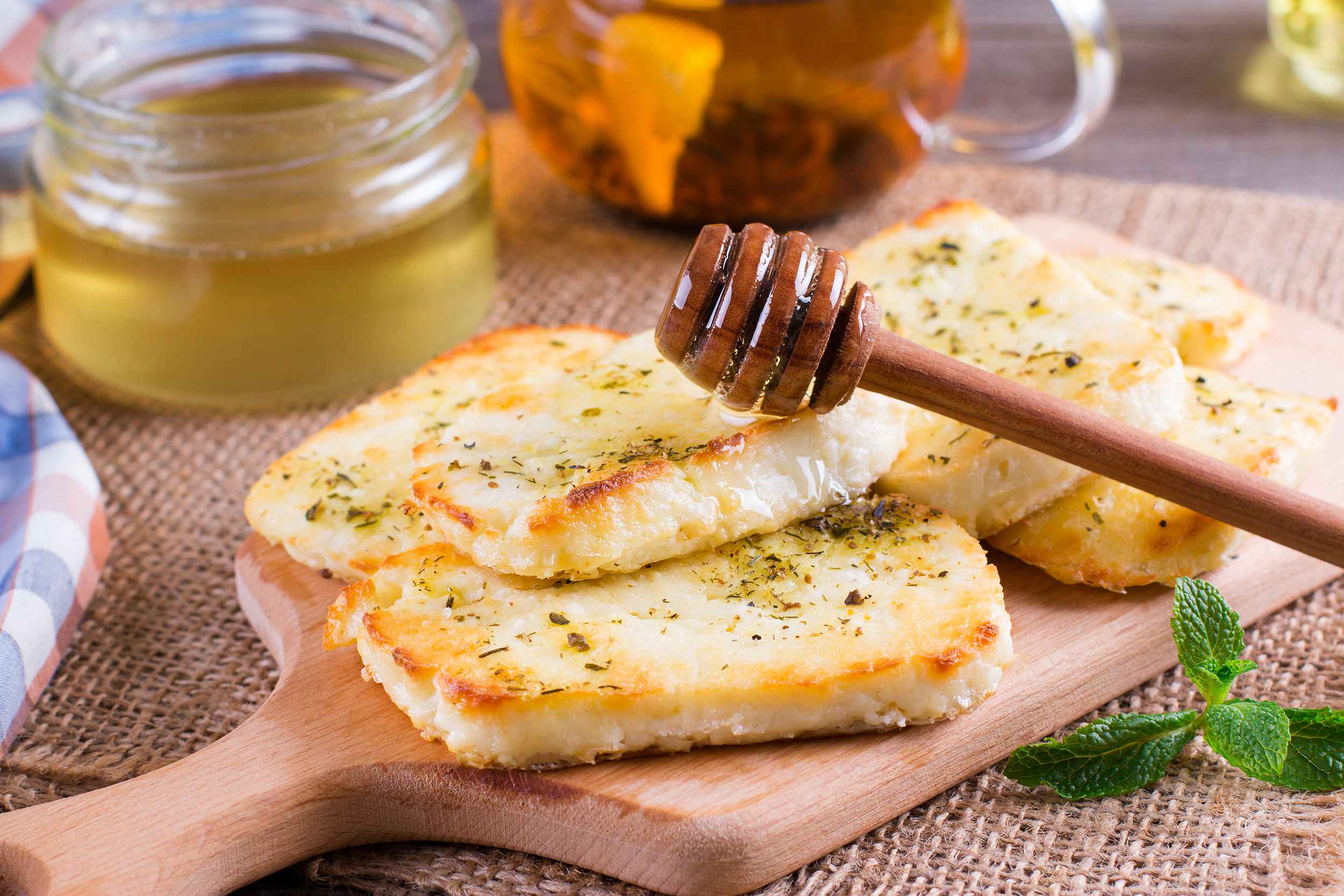 Grilled,Haloumi,Cheese,With,Herbs,And,Honey,On,A,Cutting