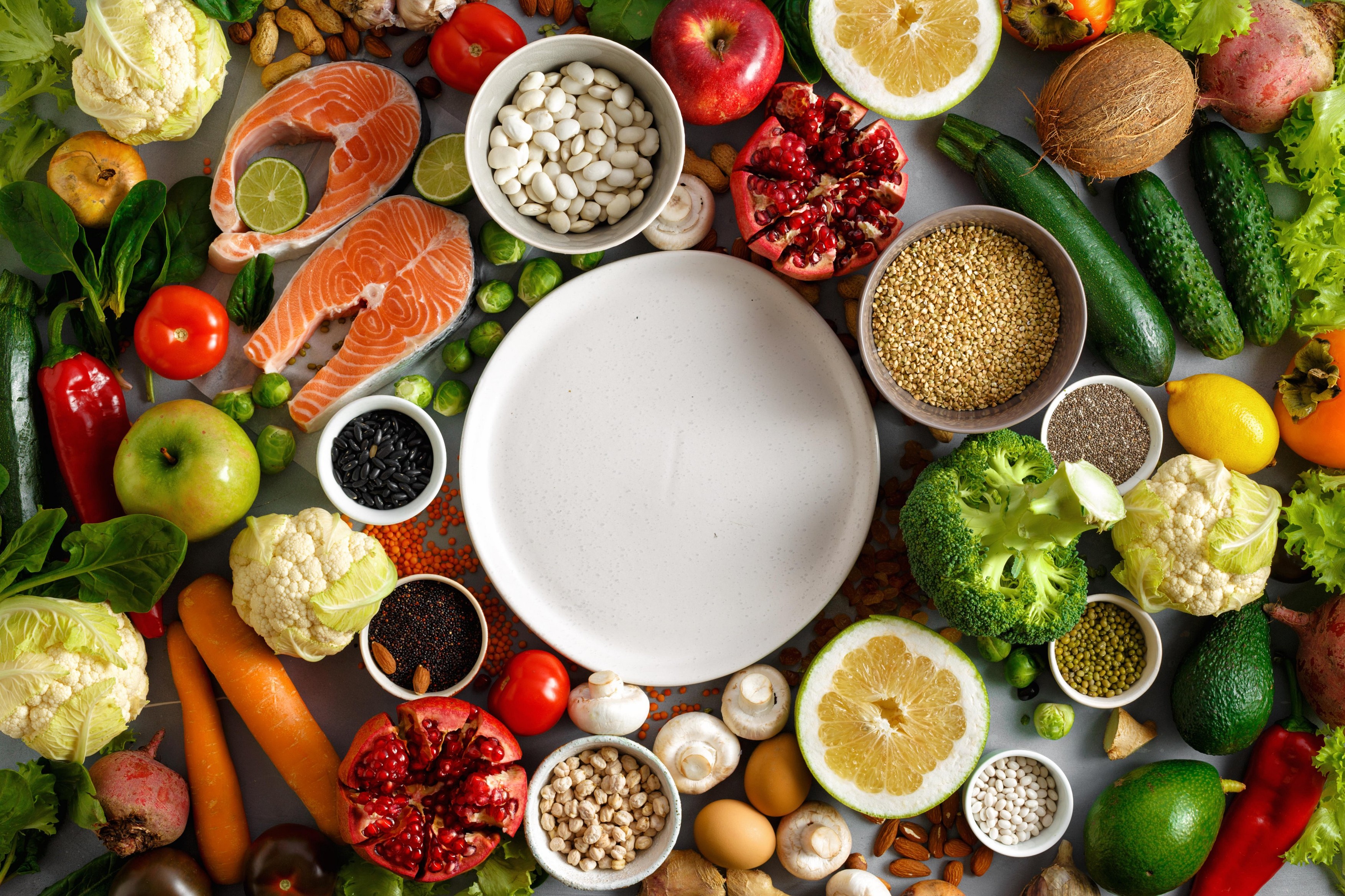 Empty round plate with set healthy and diet food (cereals, seeds, fish, vegetables and fruits). Healthy and diet menu of restaurant concept