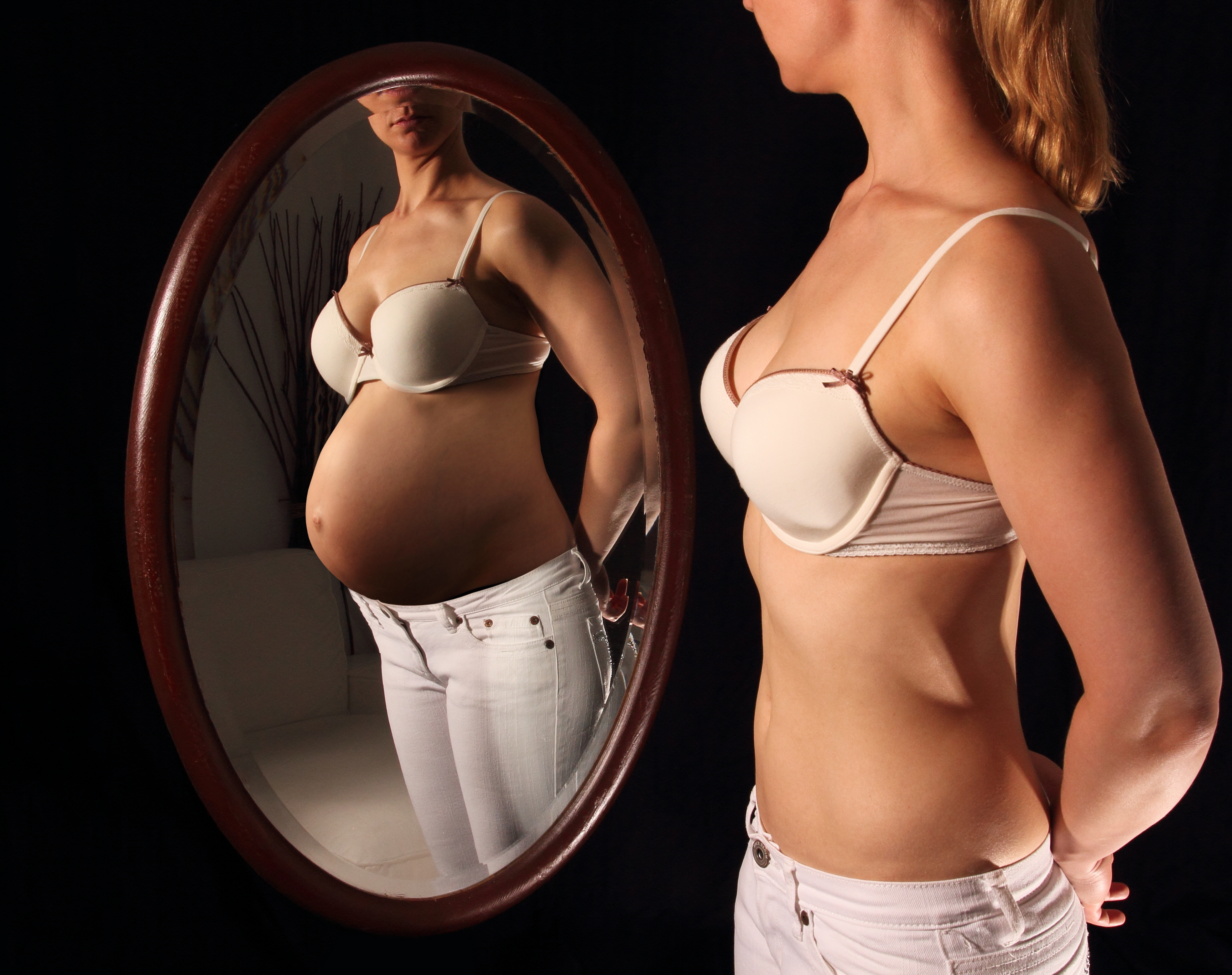 Woman,Seeing,Herself,Pregnant,In,A,Mirror